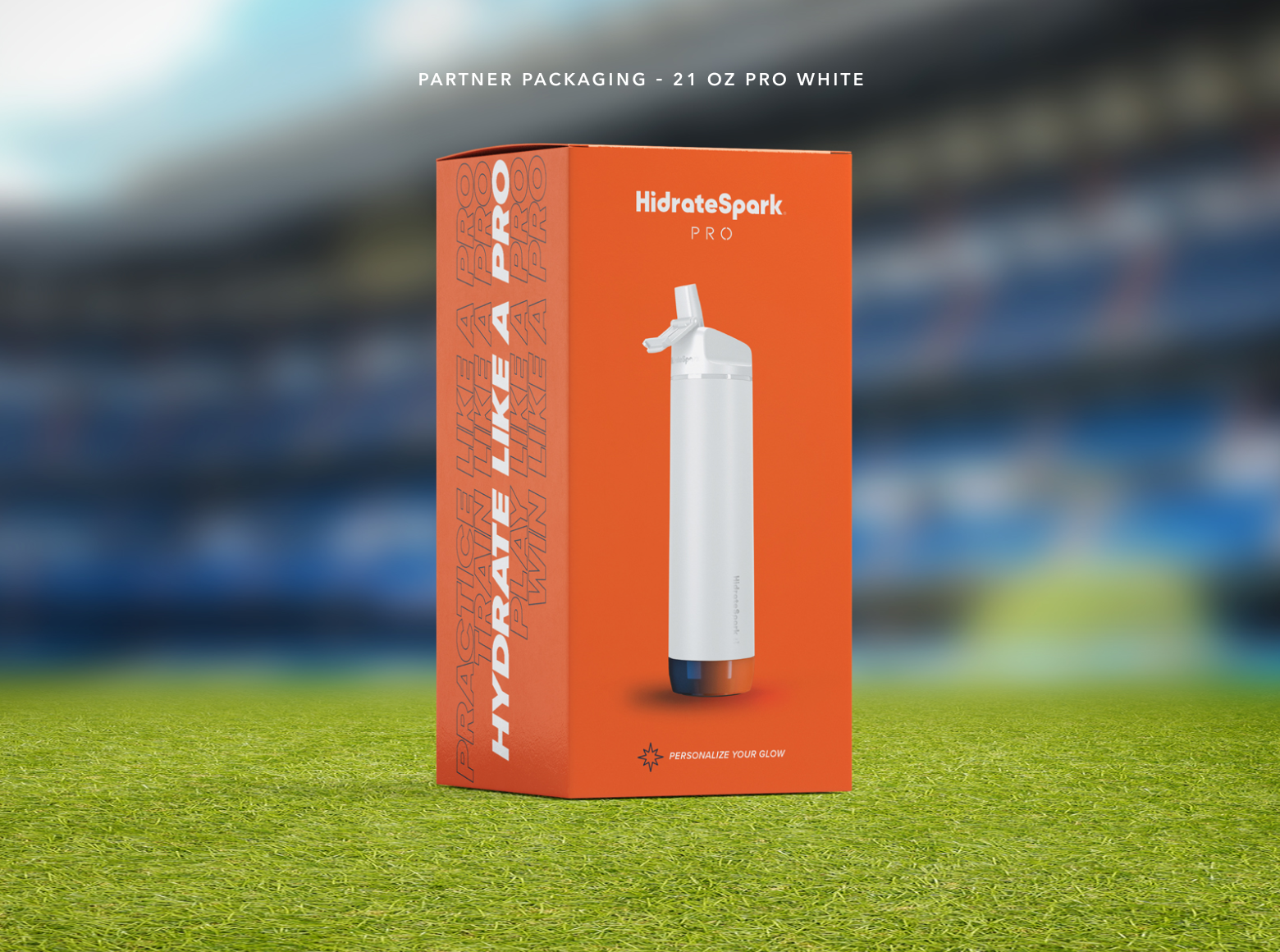 Orange HidrateSpark Pro 21-ounce water bottle packaging featuring a white smart bottle on grass