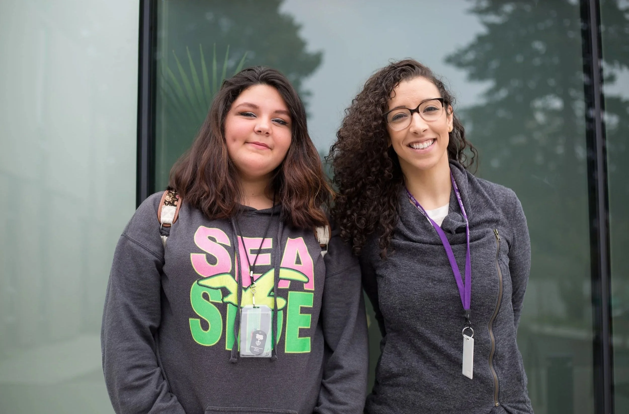 Two smiling Open School community members standing side by side