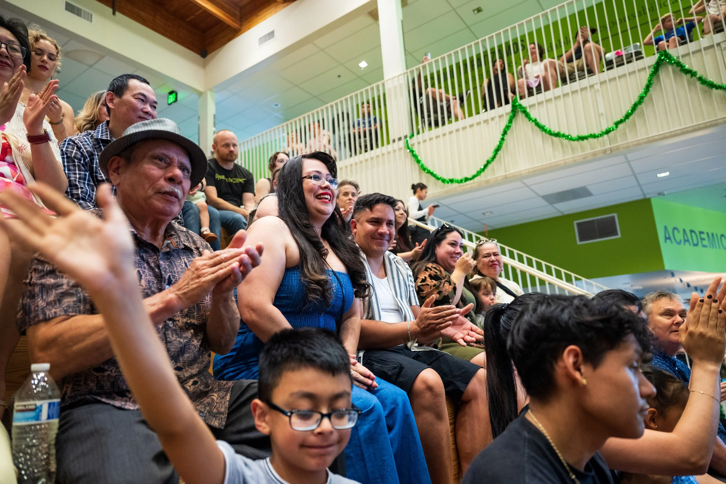 Families and community members cheering together at an Open School East graduation ceremony