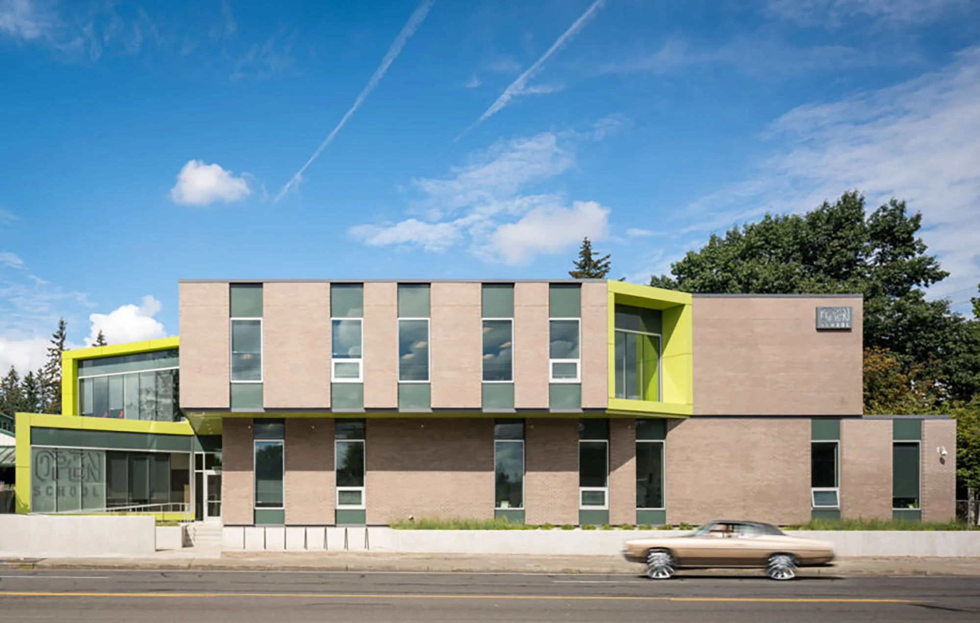 Open School main building on SE Oak Street in Portland, a two-story brick and glass school with green accents
