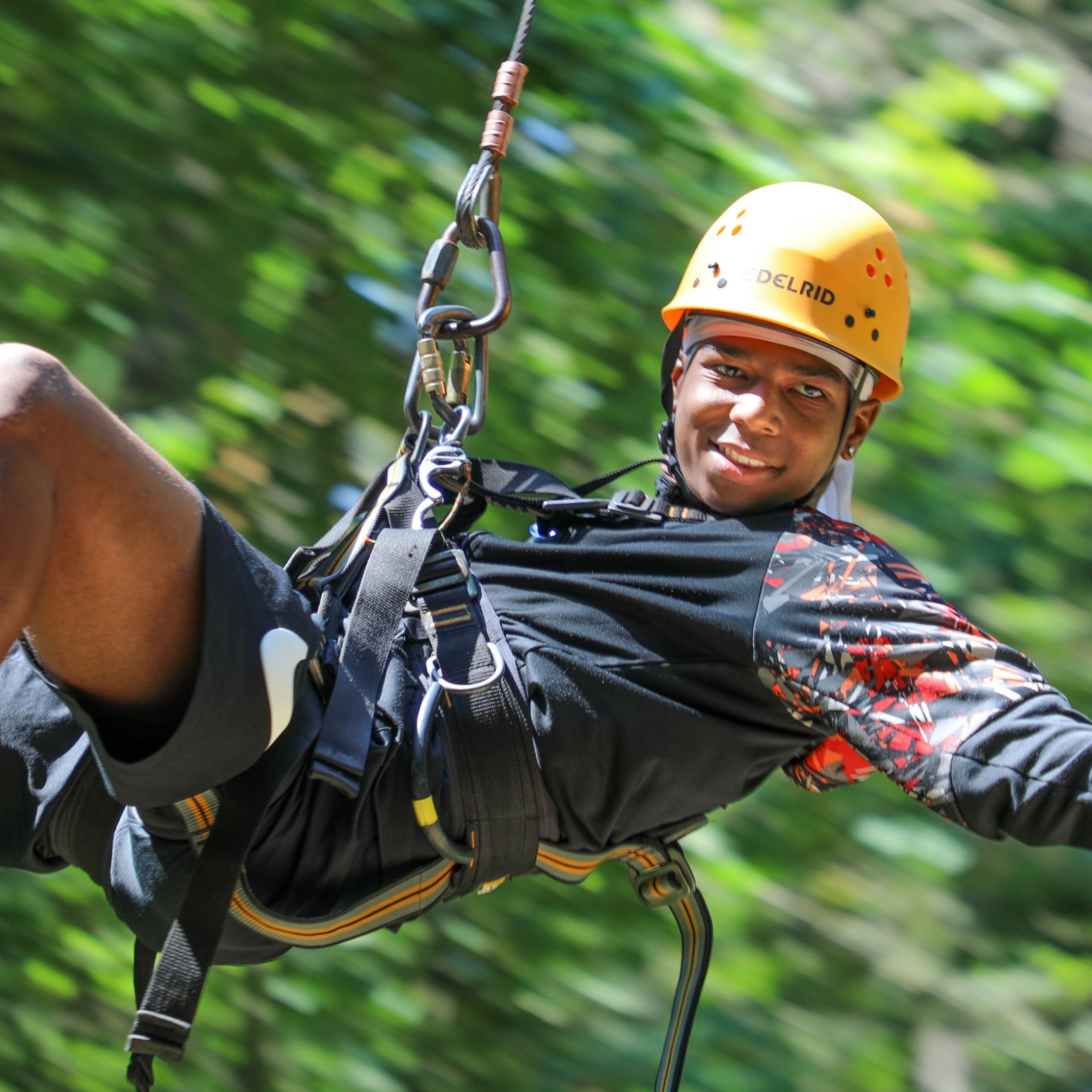 A Step Up student in a helmet rappelling down a rope at a leadership camp