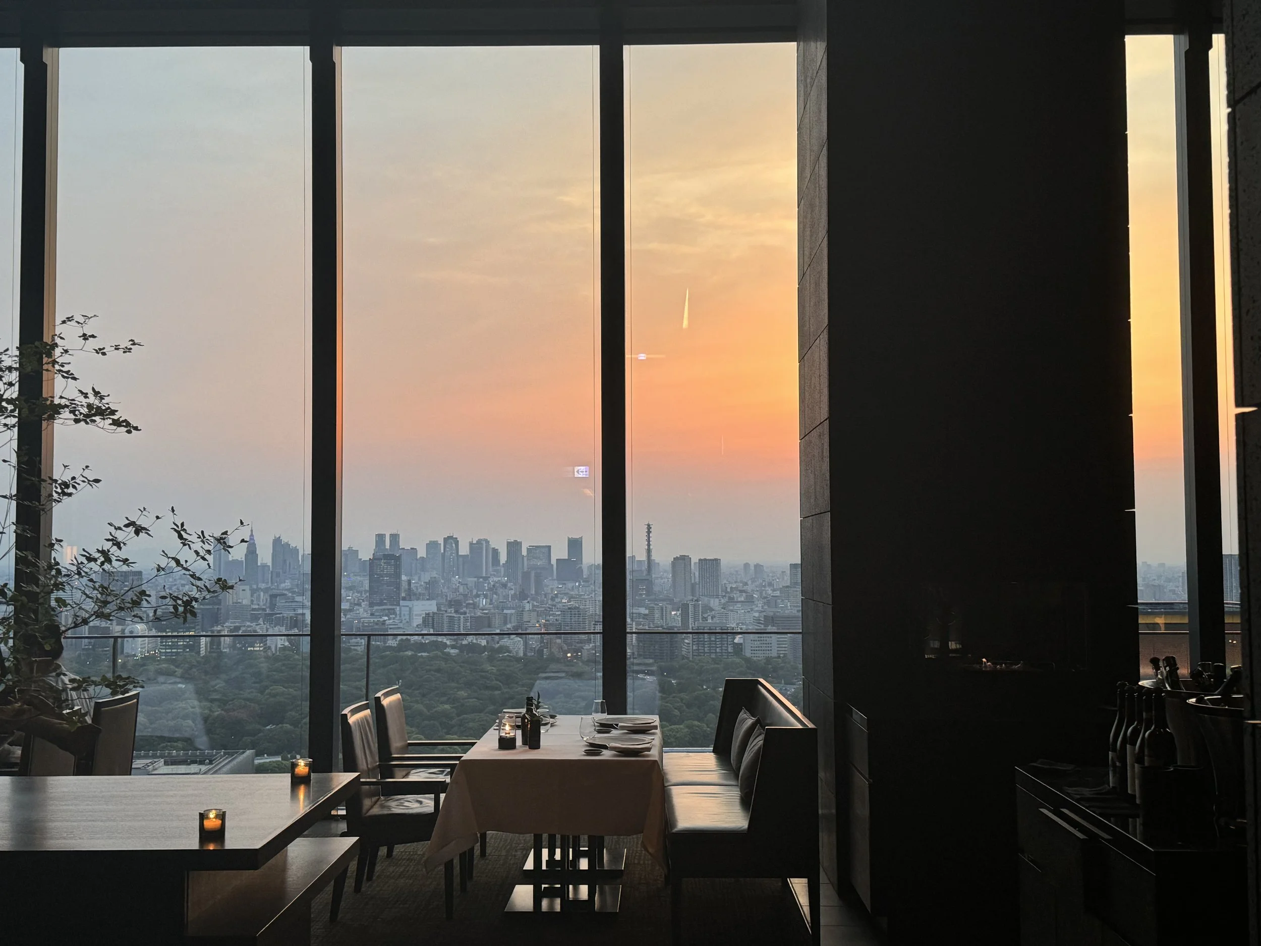 City skyline at sunset seen from a hotel restaurant window