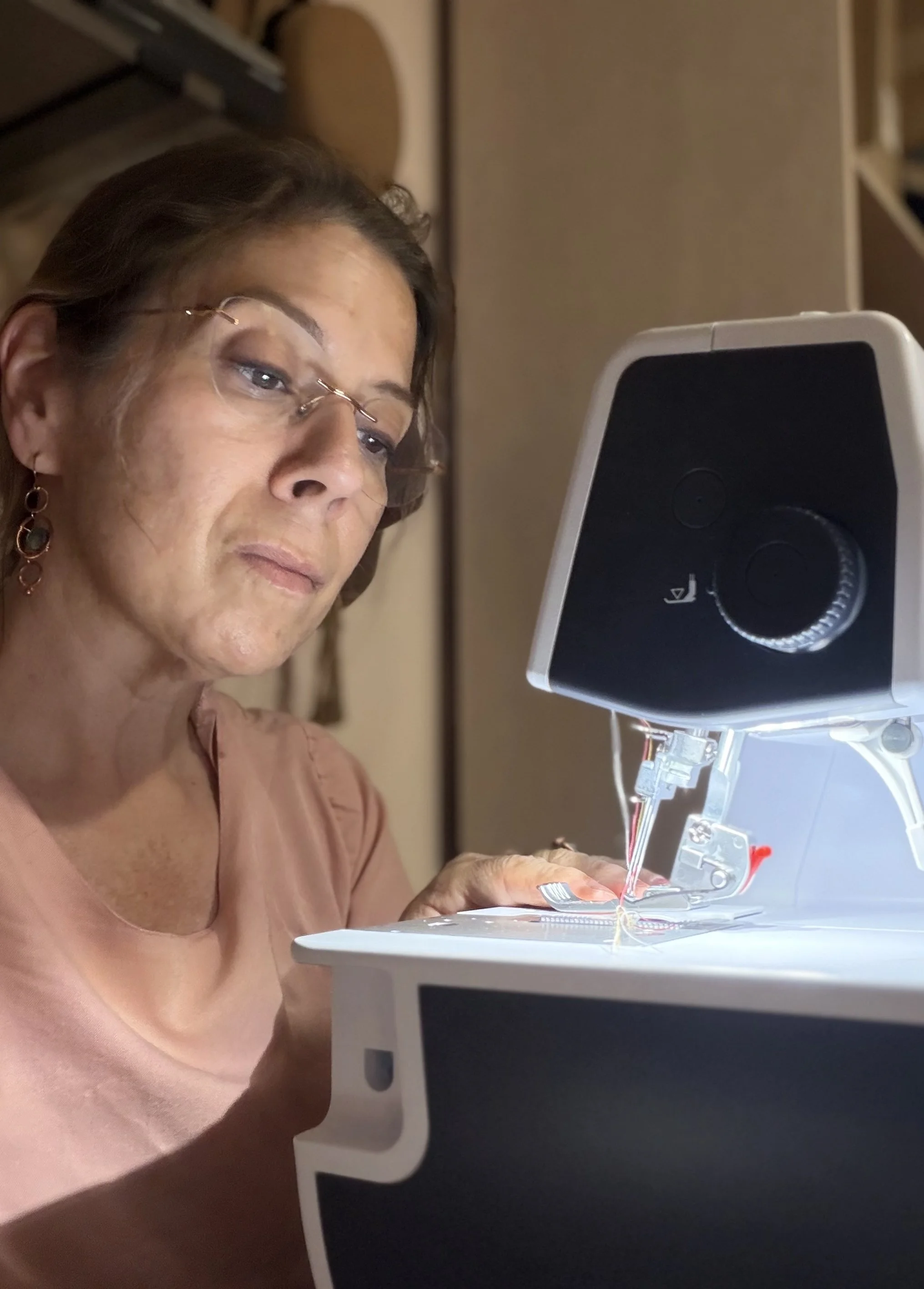 A woman with glasses using a 3D bioprinter to print a biological tissue or organ, with the printer emitting a filament of bio-ink.