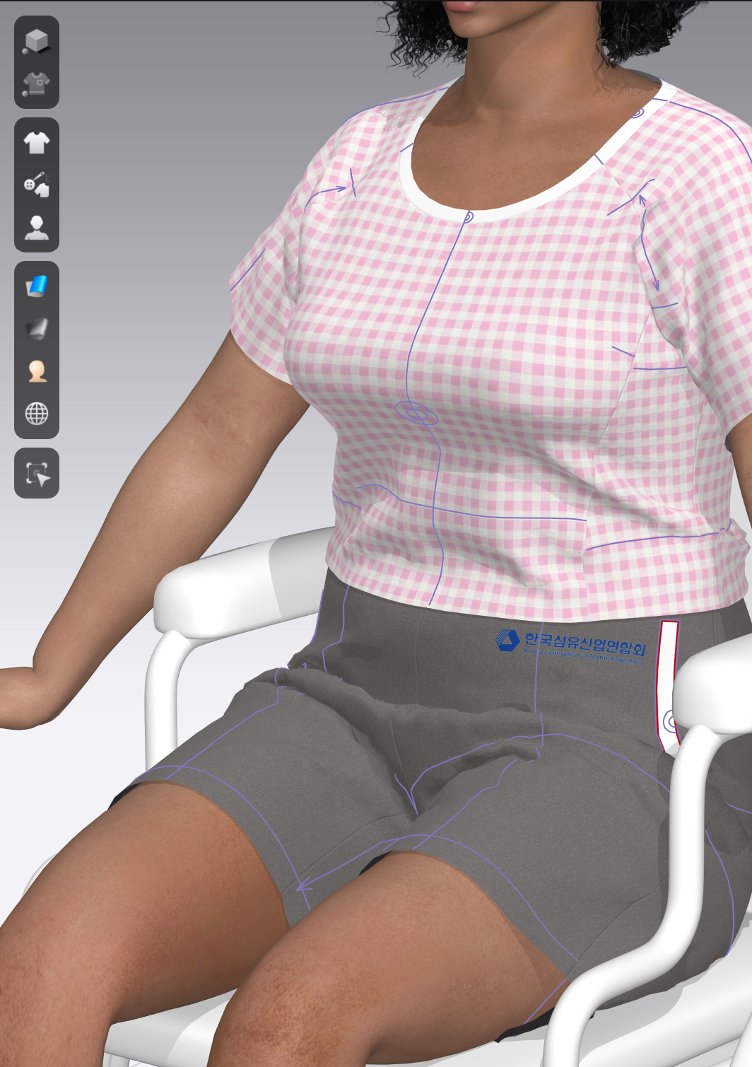 A 3-D image of a woman sitting in a wheelchair  their lap, wearing a pair of shorts and a pink gingham shirt that has been altered..