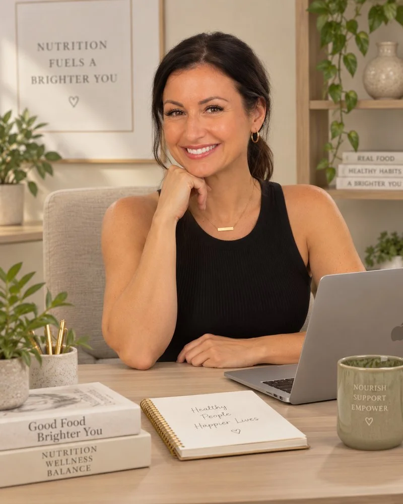 Ashley Lambert, RDN, registered dietitian for gut health and menopause, smiling at her desk