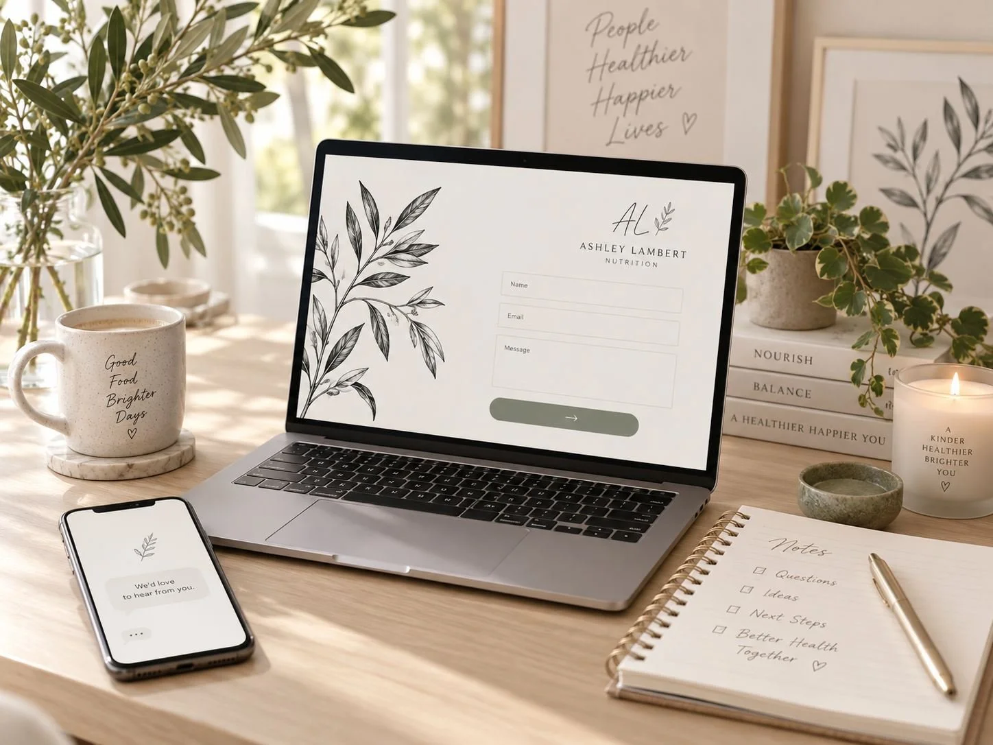 Laptop and phone on a desk showing the Ashley Lambert Nutrition website