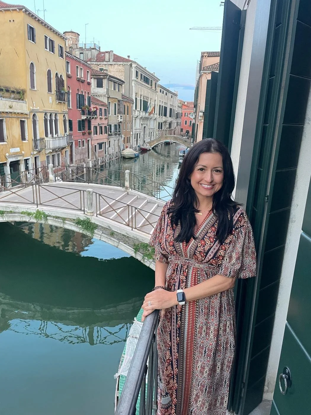 Ashley Lambert, RDN, LDN, online registered dietitian, standing on a balcony above a canal
