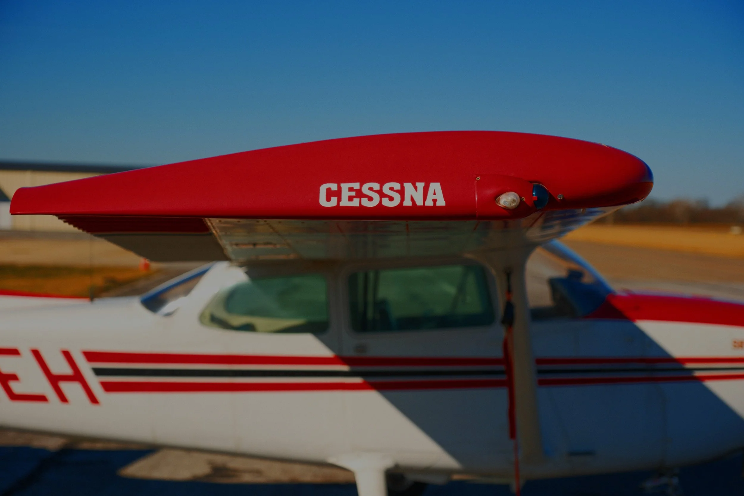 Close-up of a red and white aircraft or drone with the word 'CESSNA' printed on top, against a clear blue sky.