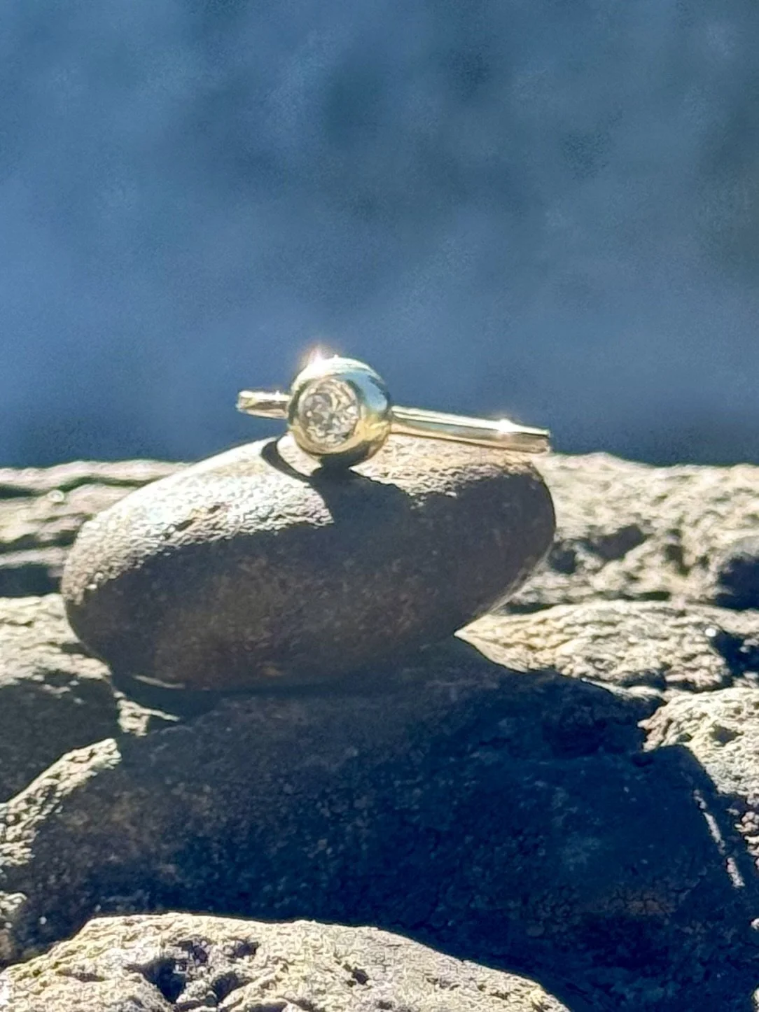 A handmade 14K gold ring in an organic ingot style, flush set with an Old European cut diamond. Great for stacking. These are made to order using gemstone of your choice, color and size.