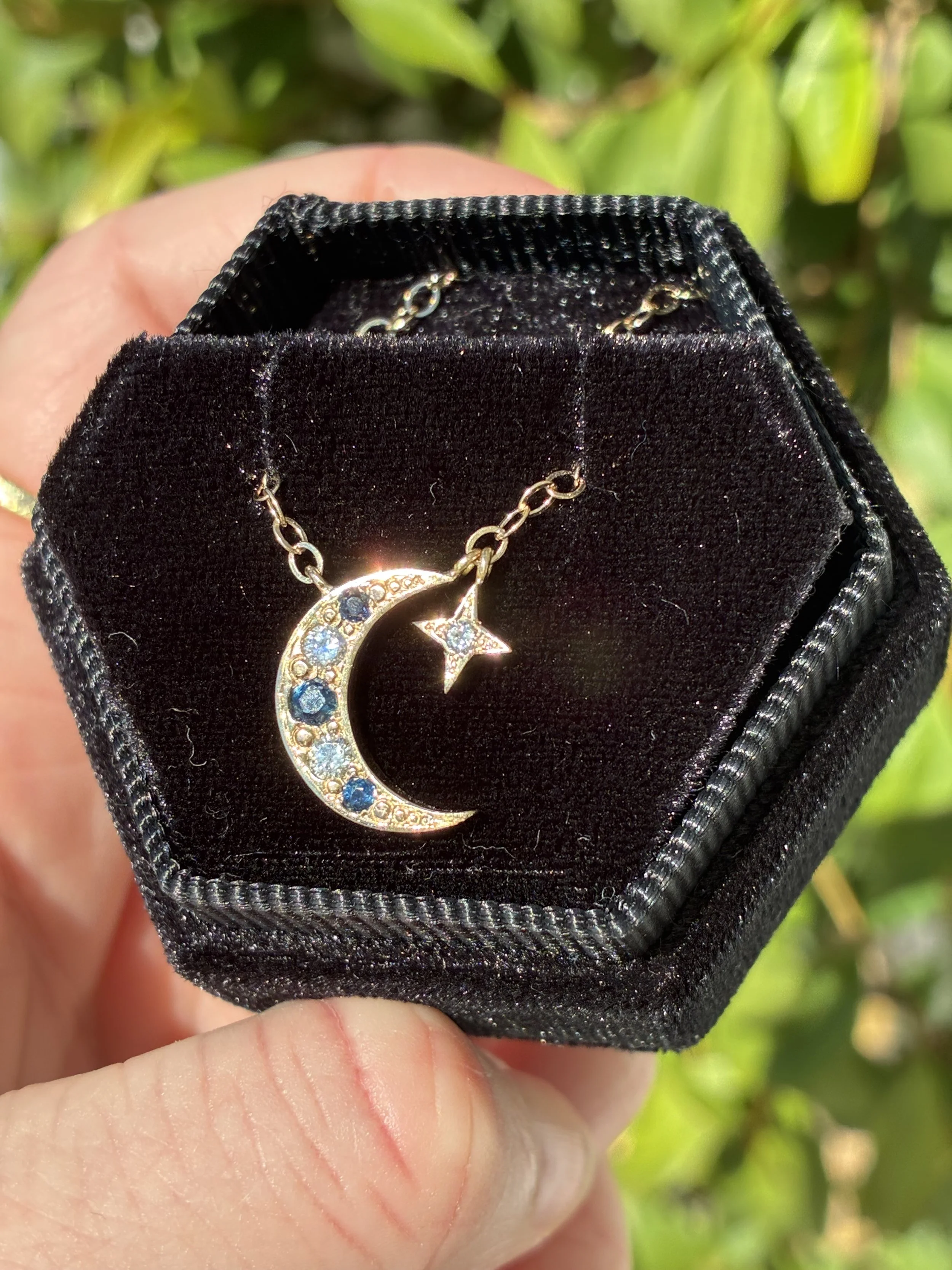 14K gold waning moon and North Star necklace with diamonds and sapphires, made using the client’s recycled gold and gemstones.