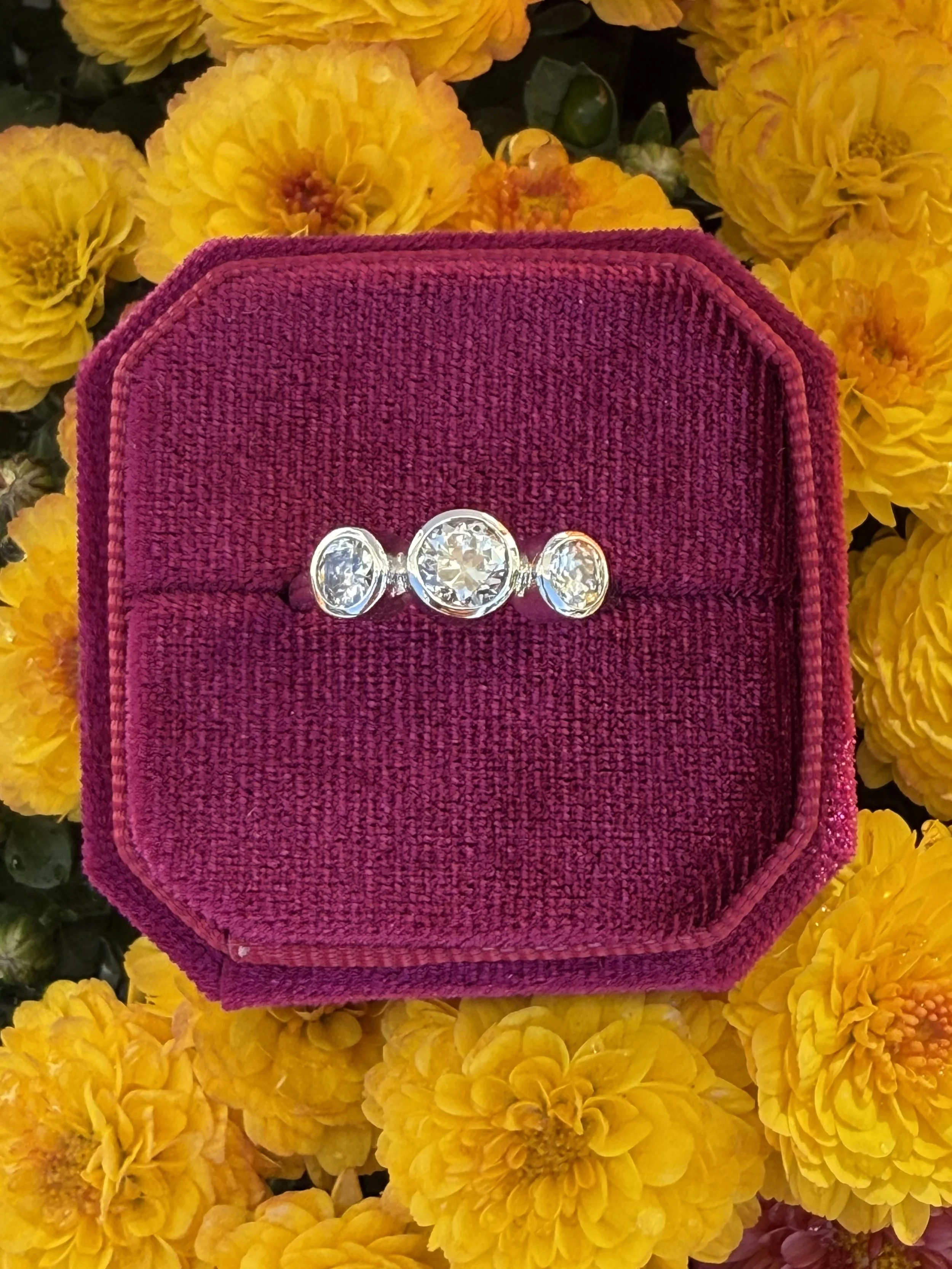 Custom bezel set 3 stone diamond ring.