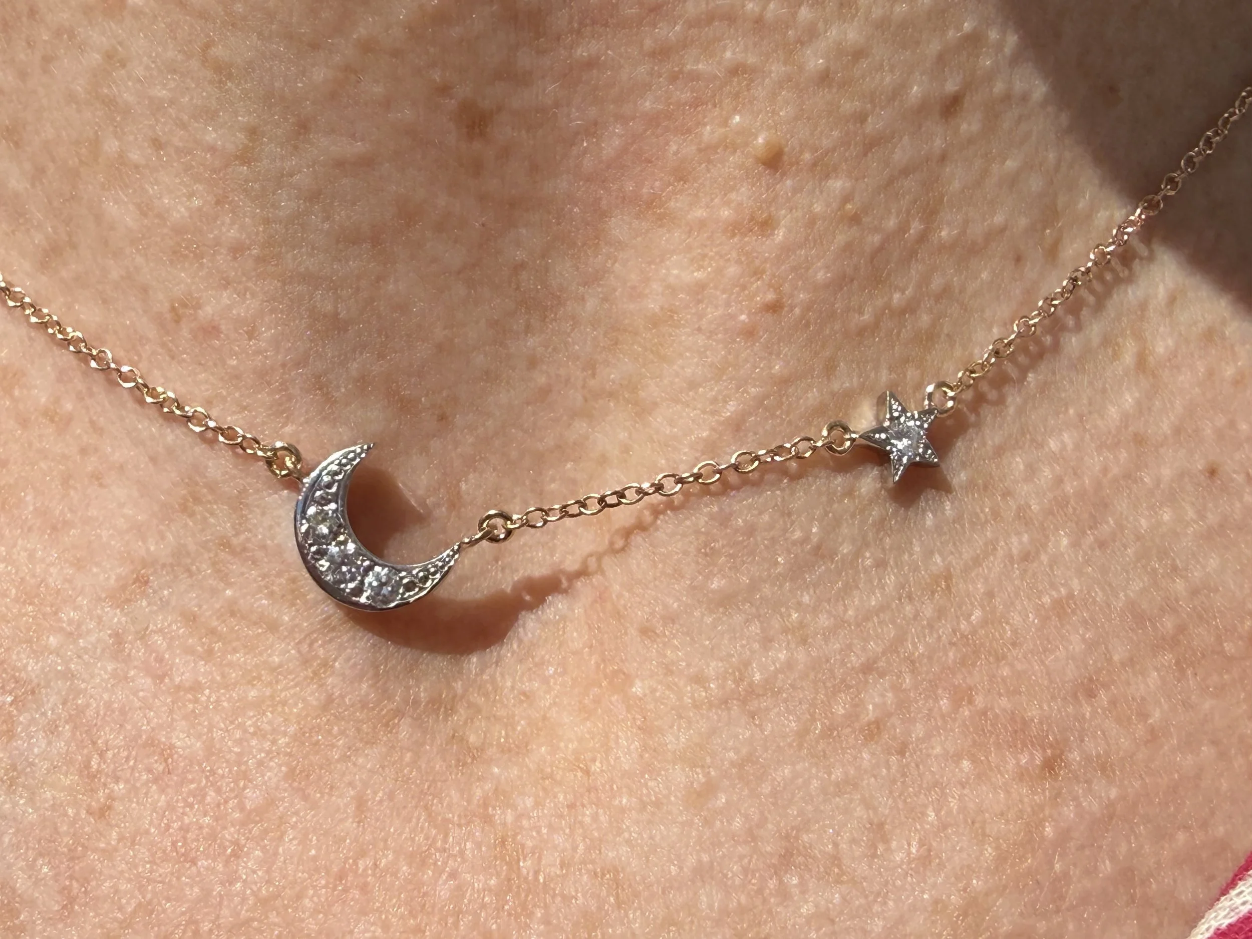The "Wandering Star," necklace: a 14K gold chain with a 14K white gold moon and star, each set with diamonds. 