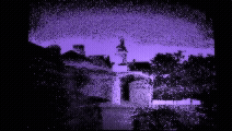 Silhouette of buildings and trees at night with purple sky and reflections on water