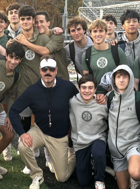 Freddy Cavin (dressed as Ted Lasso) with high school soccer players after a match.