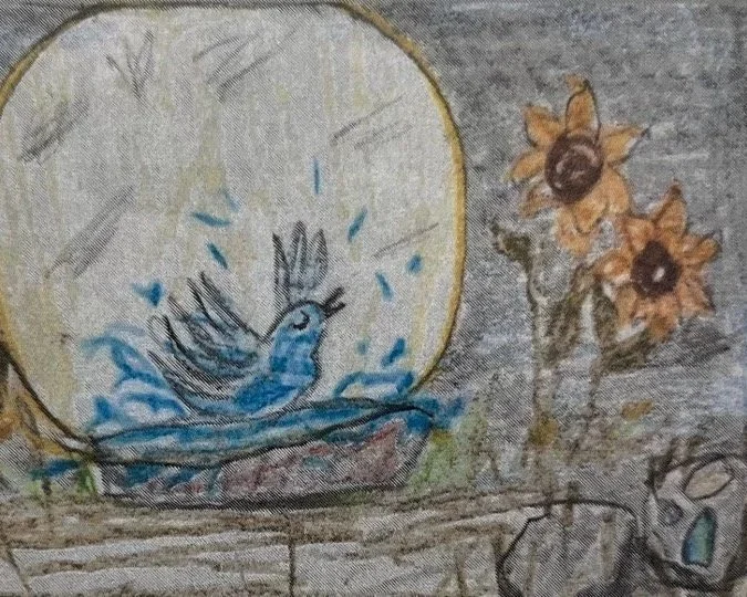 A painted blue bird in a nest inside a circular frame with yellow border, next to a small bunch of yellow flowers with brown centers.
