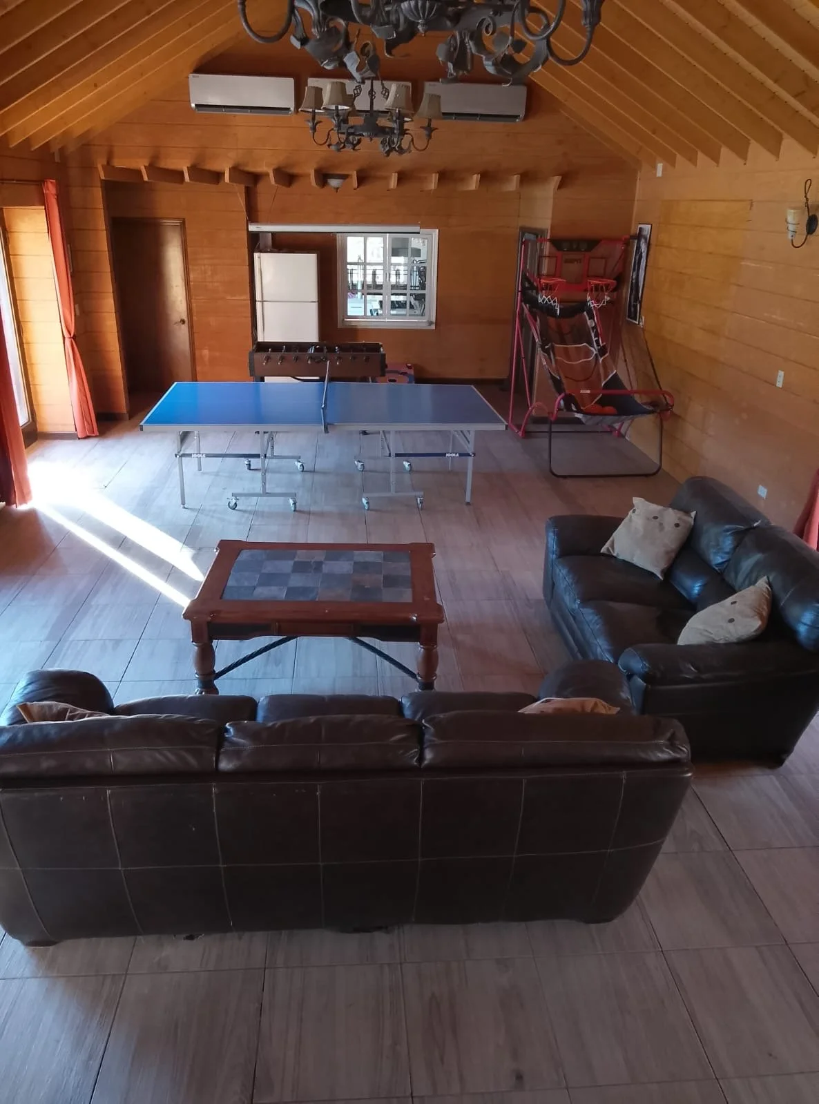 Entertainment room with spacious seating area and games.