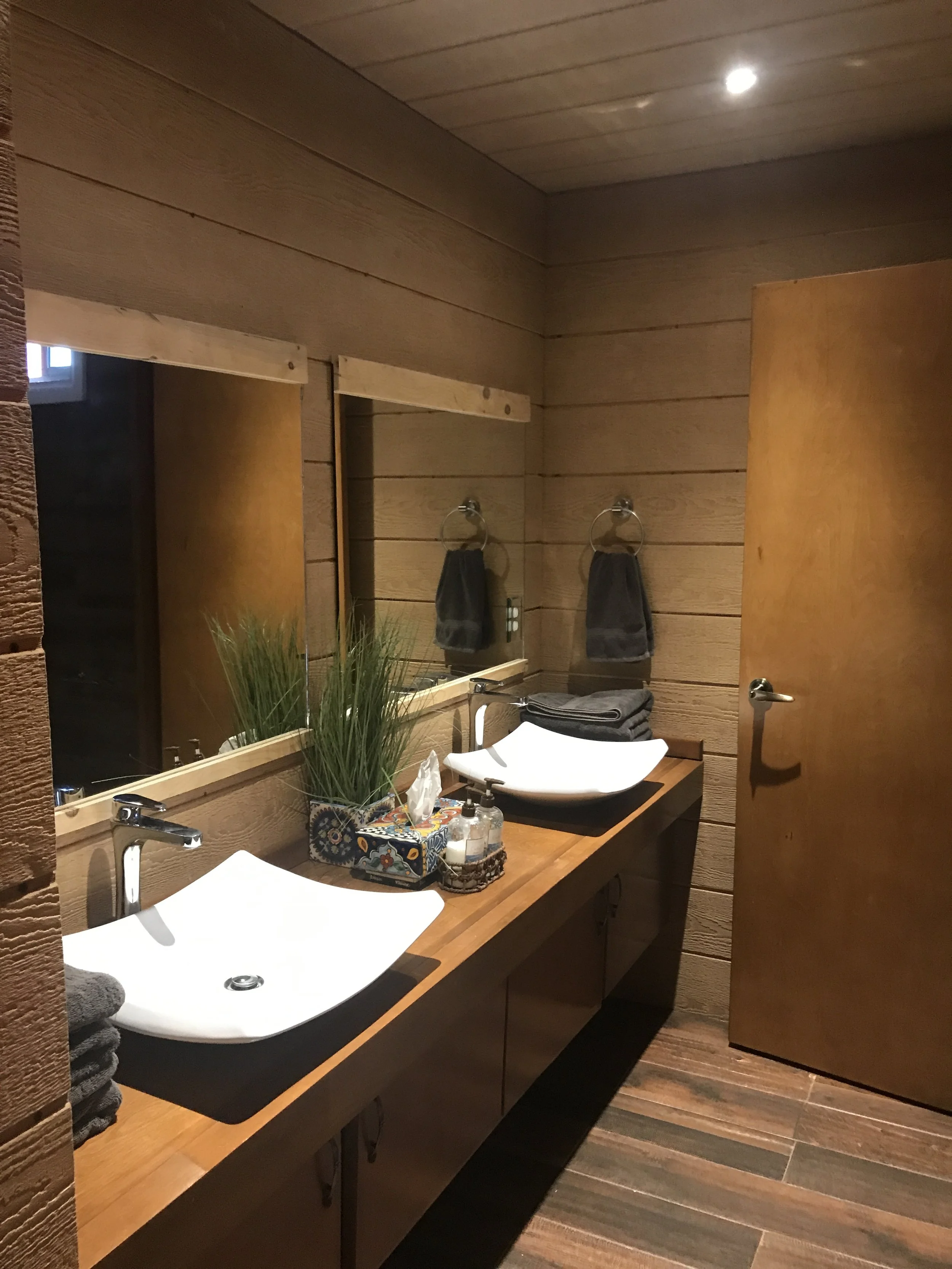 Spacious bathroom with a large vanity at Baja Vineyard Lodge.
