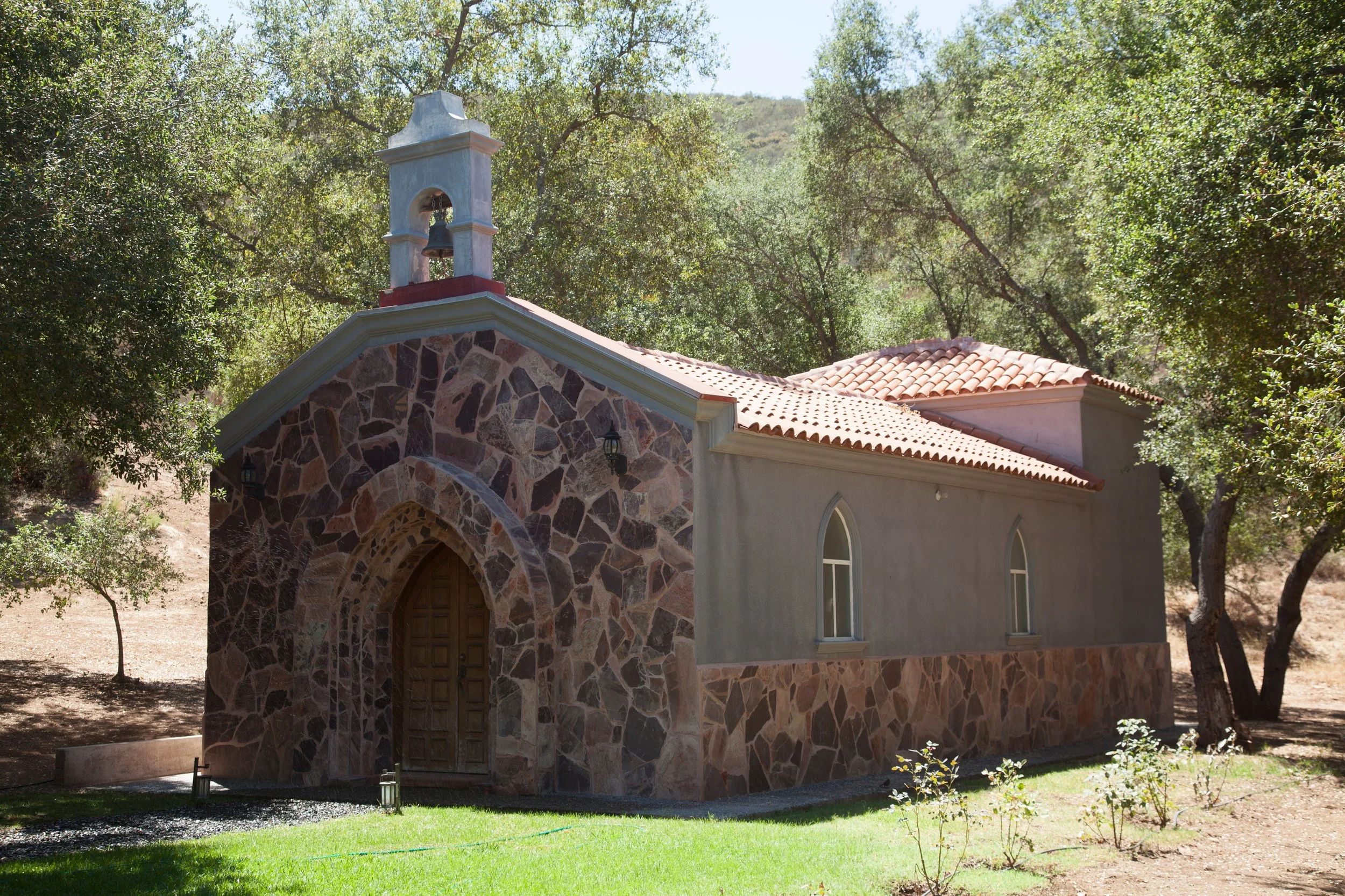 Private stone chapel set among the oak trees at Baja Vineyard Lodge.