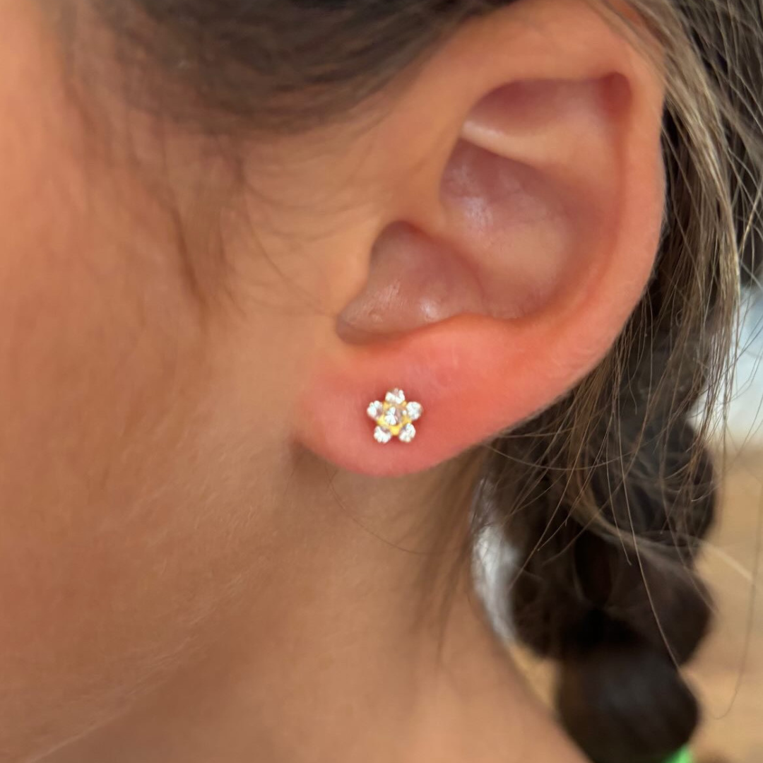 star earring on pierced ear