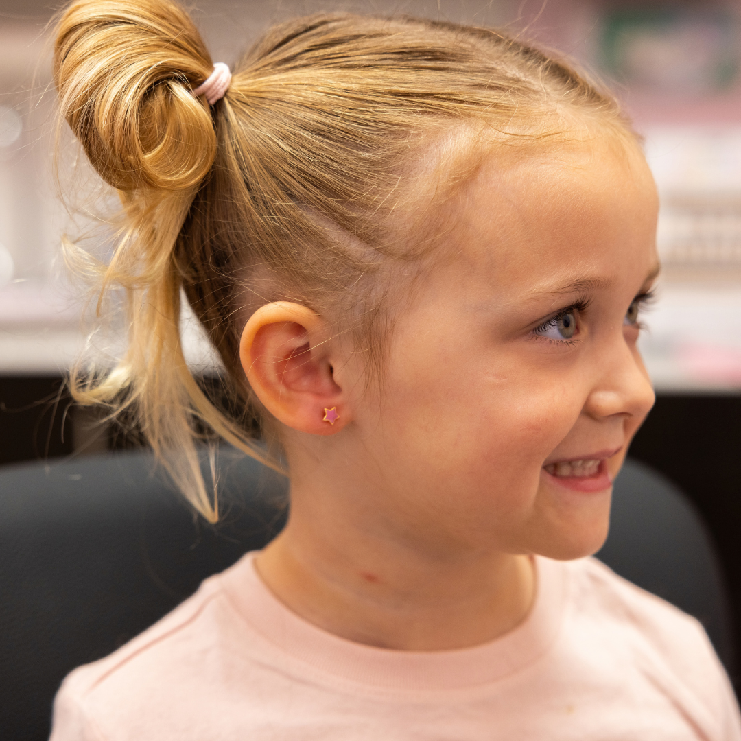 young girl with new ear piercing