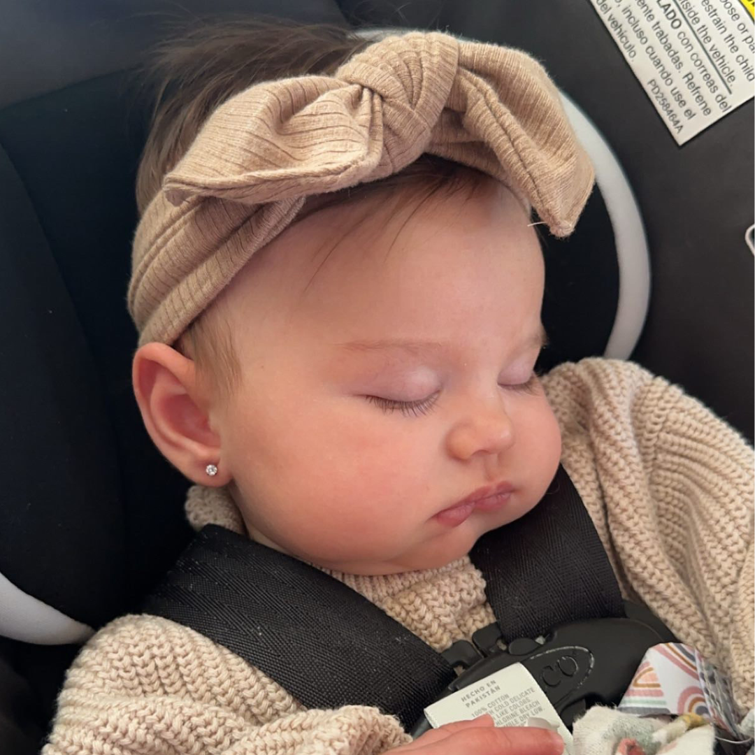 sleeping baby with pierced ears
