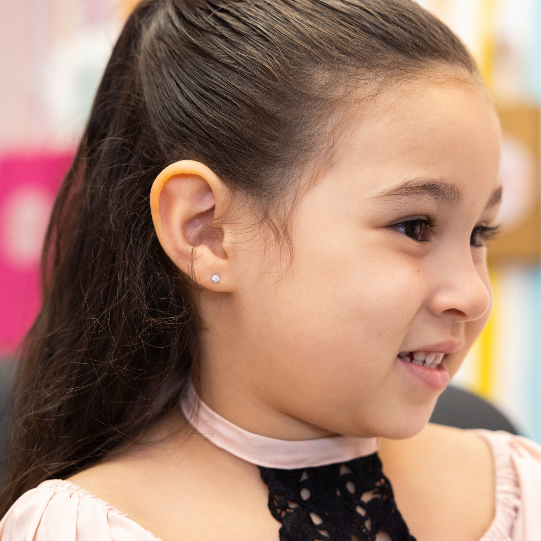 young girl showing pierced ear
