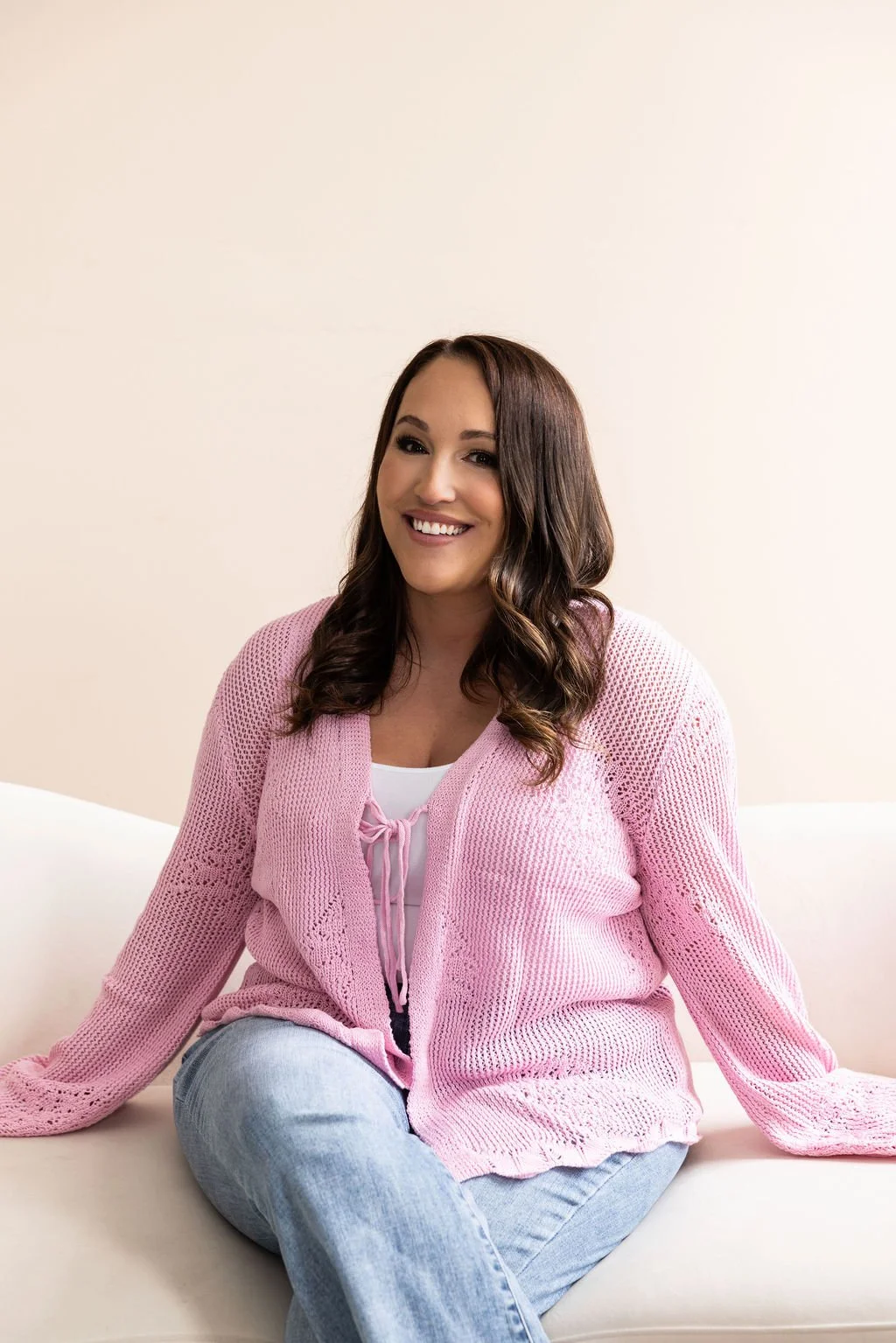 jaclyn owner of pearl and poppy on couch