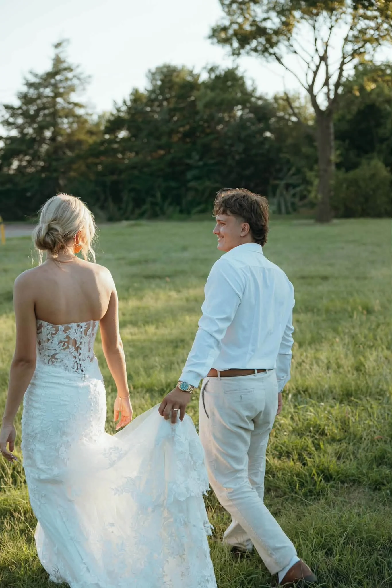 Laurie’s customers, Fernando and Kate embracing by the lake on their wedding day.