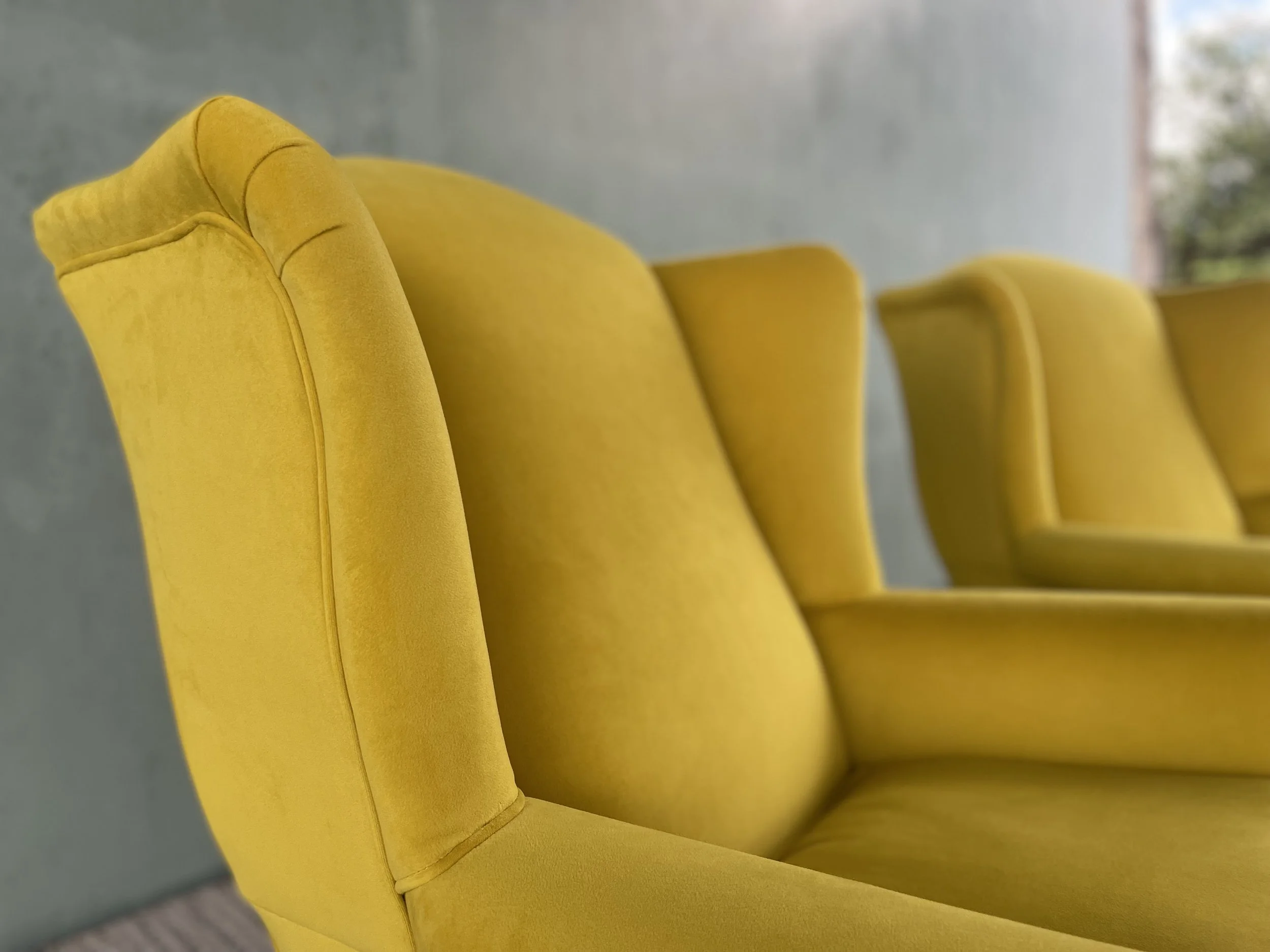close up image of yellow velvet armchair
