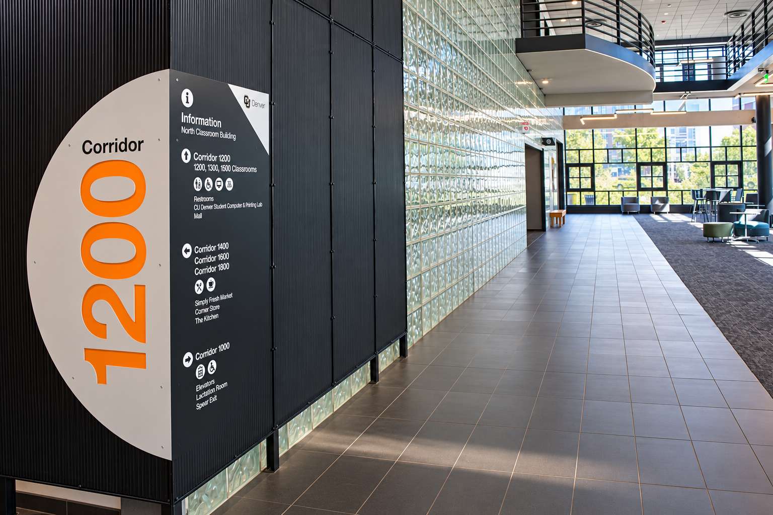 Modern Campus Corridor with Wayfinding Sign.png
