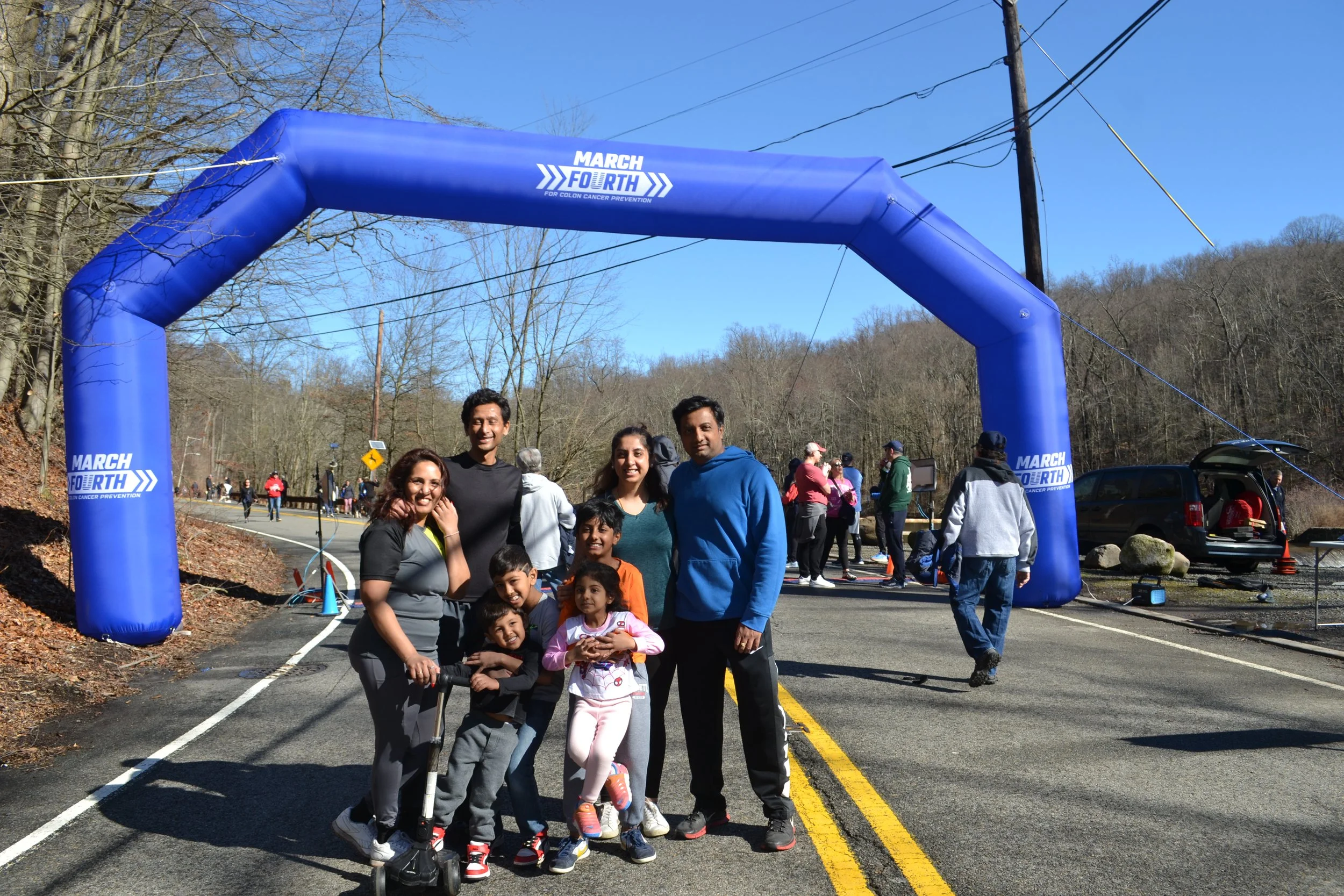 Families celebrating together beneath the March Fourth arch.