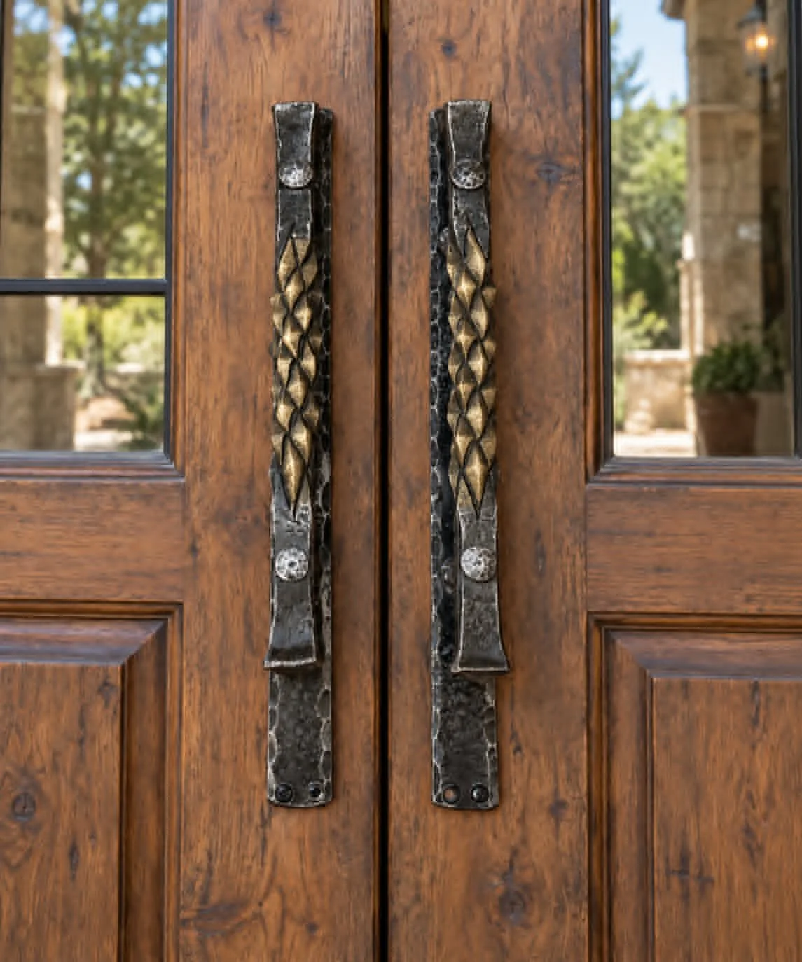 Hand-forged door pulls with pineapple twist and brass brush finish