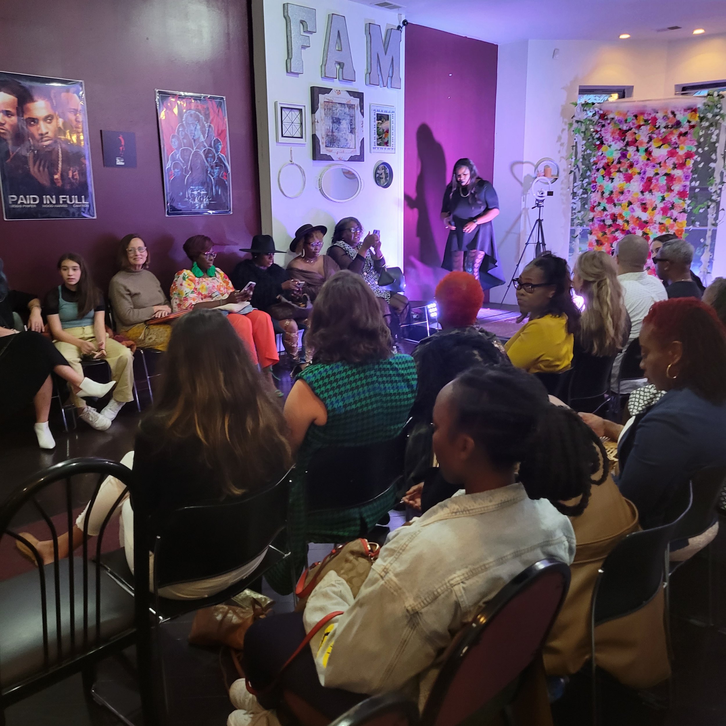 Crowded evening Open Mic at FAM Entertainment Theater Company’s Bronzeville black-box theater in Chicago, bringing artists and community members together through live creative expression.