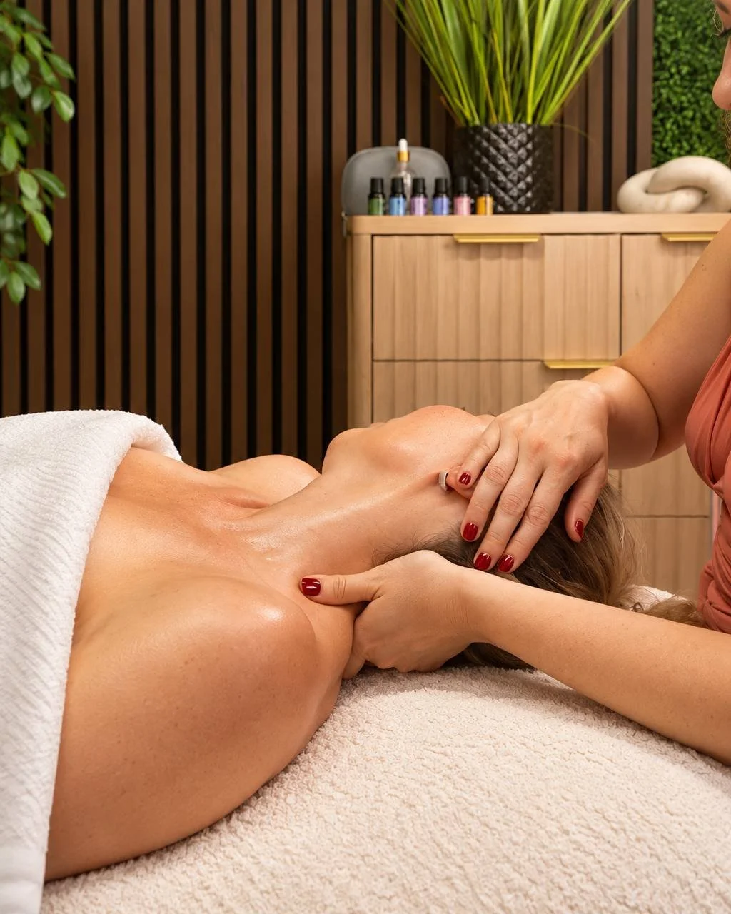 Person receiving a massage with a spa setting in the background.