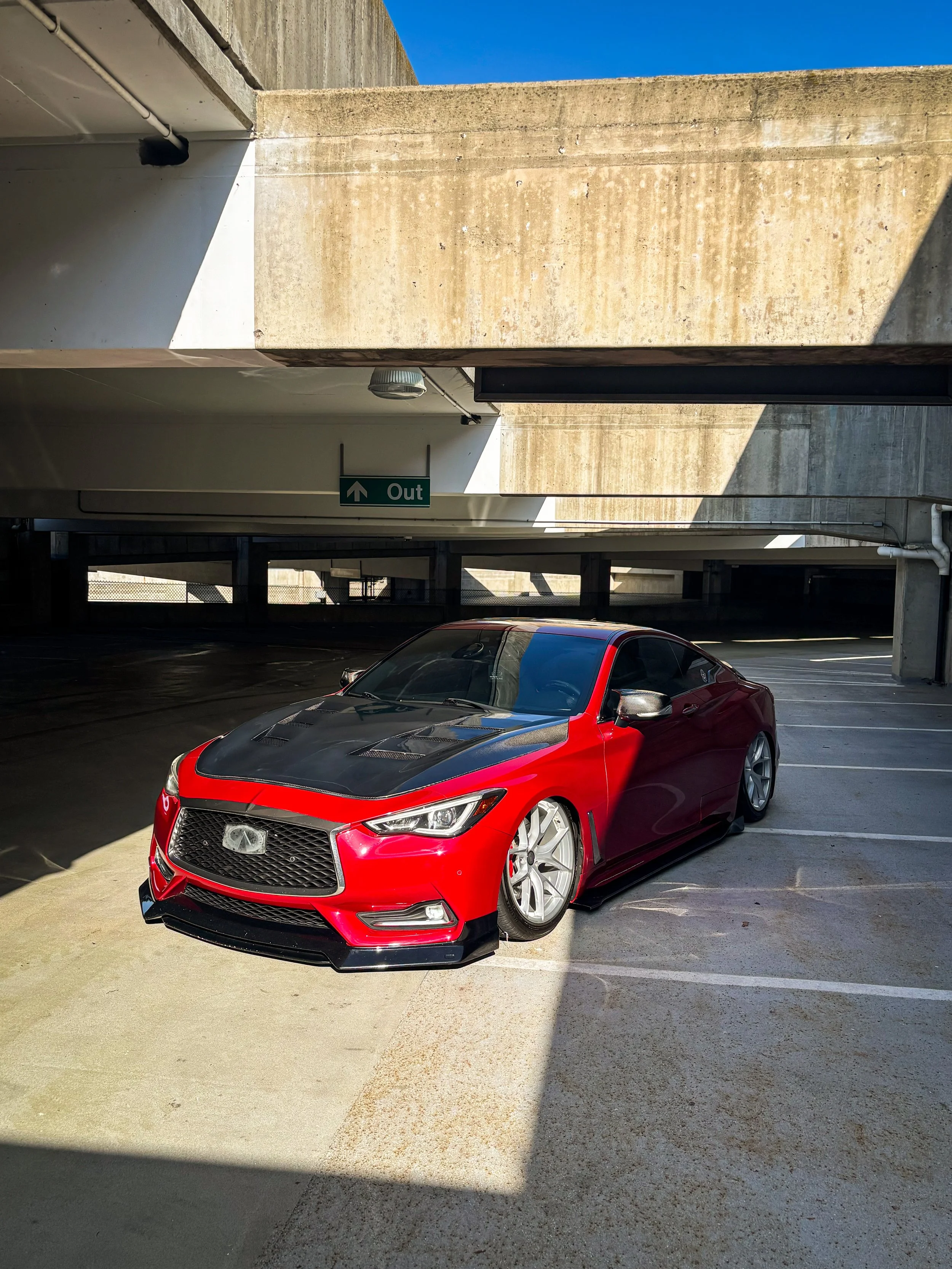 Infiniti Q60 after a full exterior wash, decontamination, and paint correction on the carbon fiber hood