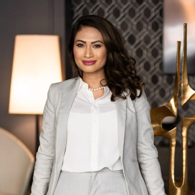 Businesswoman in gray suit standing in modern office setting