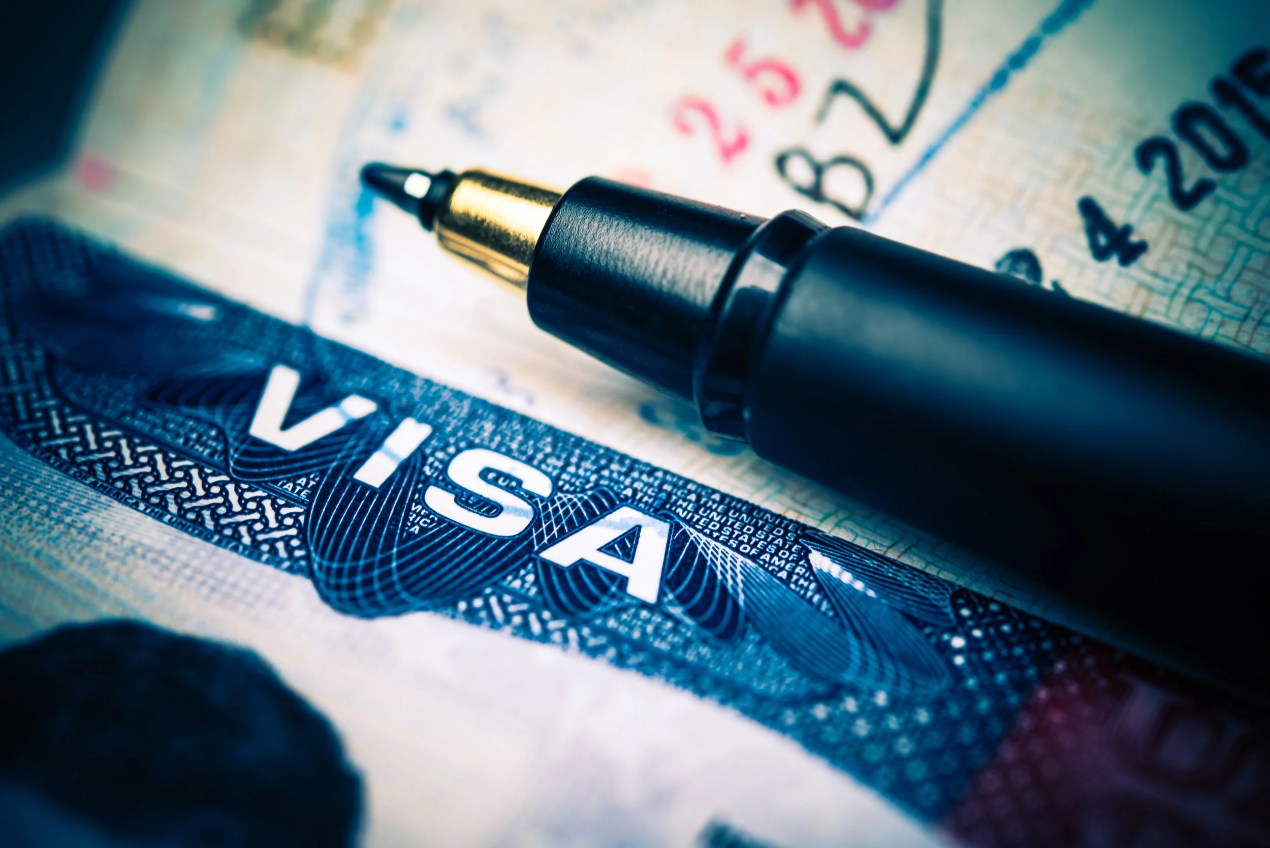 Close-up of a black marker pen resting on a US hundred dollar bill.