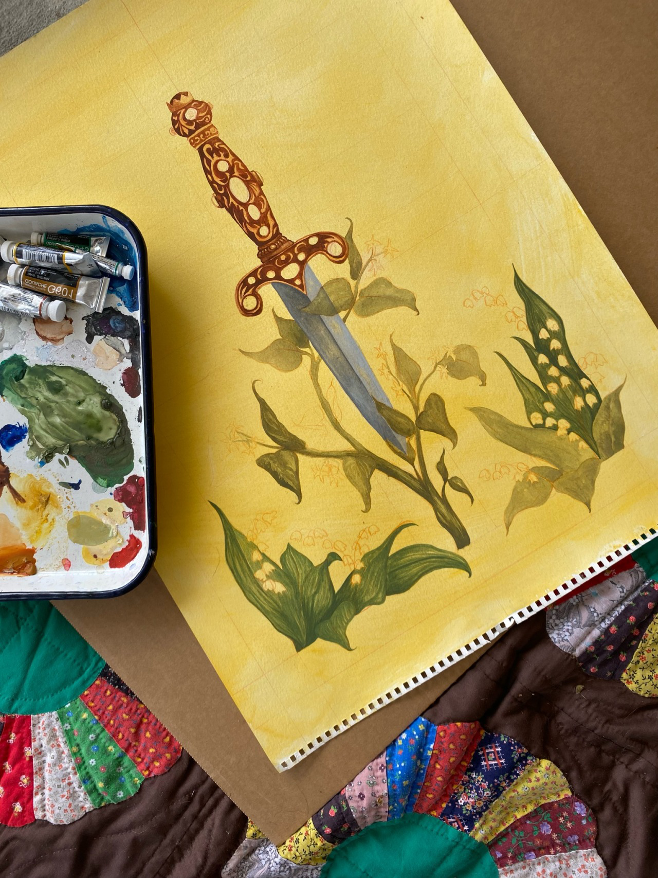 Painting of a sword with a decorative hilt, surrounded by green leaves and yellow flowers, on a yellow background, with paint palette and brushes nearby.
