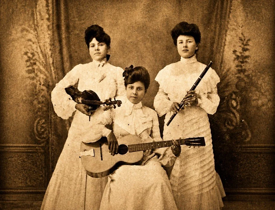 Three young women in vintage dresses pose with musical instruments, one holds a violin, another an old guitar, and the third a flute, in front of ornate curtains.