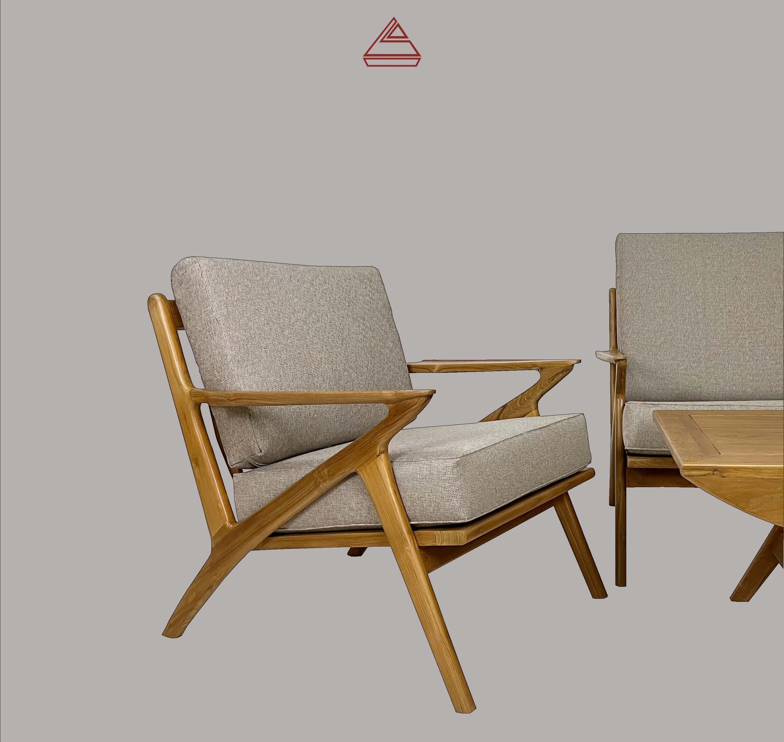 Three beige upholstered chairs with wooden frames and armrests arranged around a wooden table, against a plain light grey background.