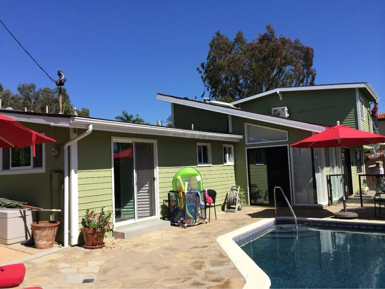Exterior repaint with pool area (green siding home)