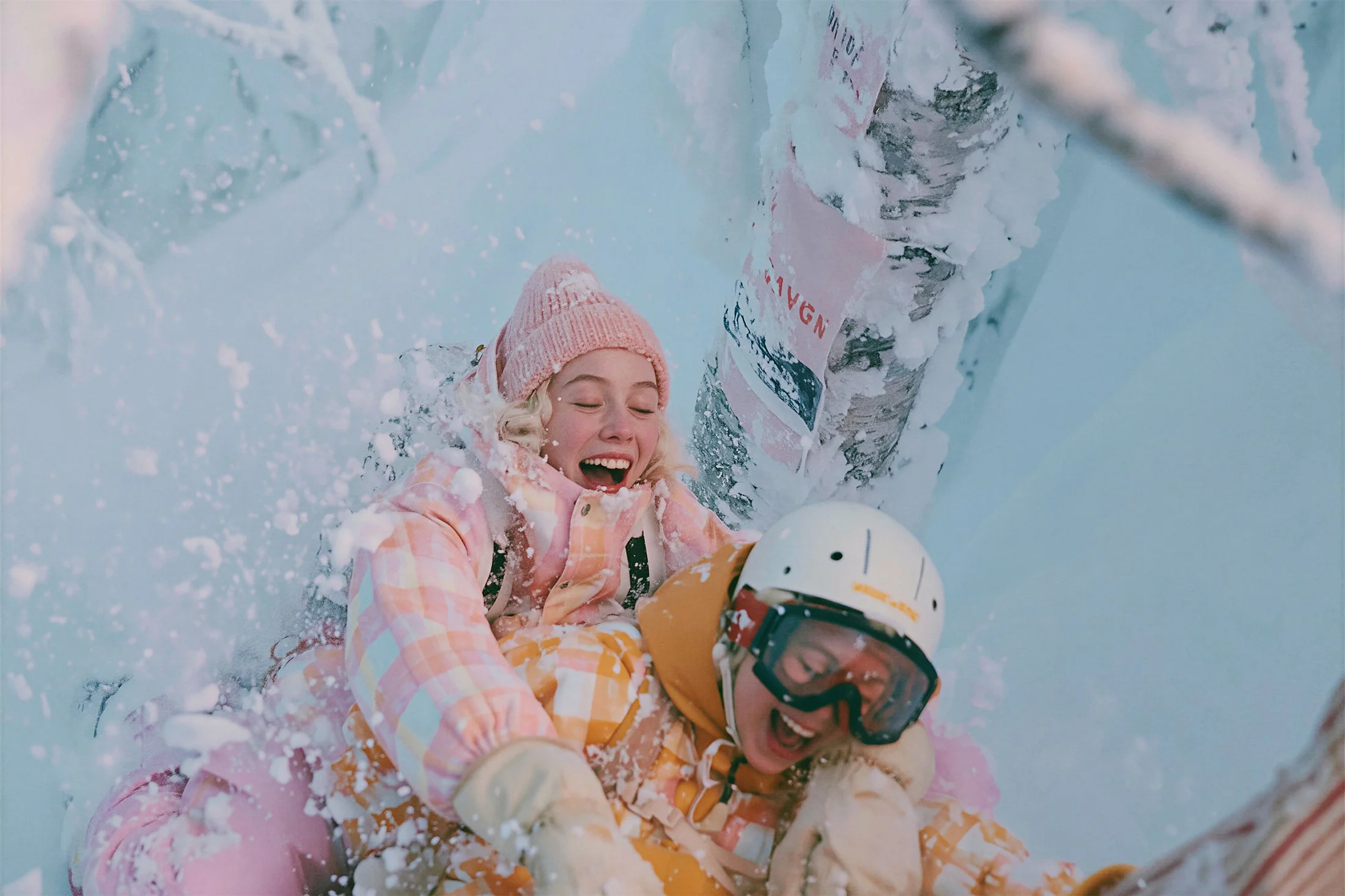 Two girls playing in the snow in pastel knits and ski goggles. AI-generated image.