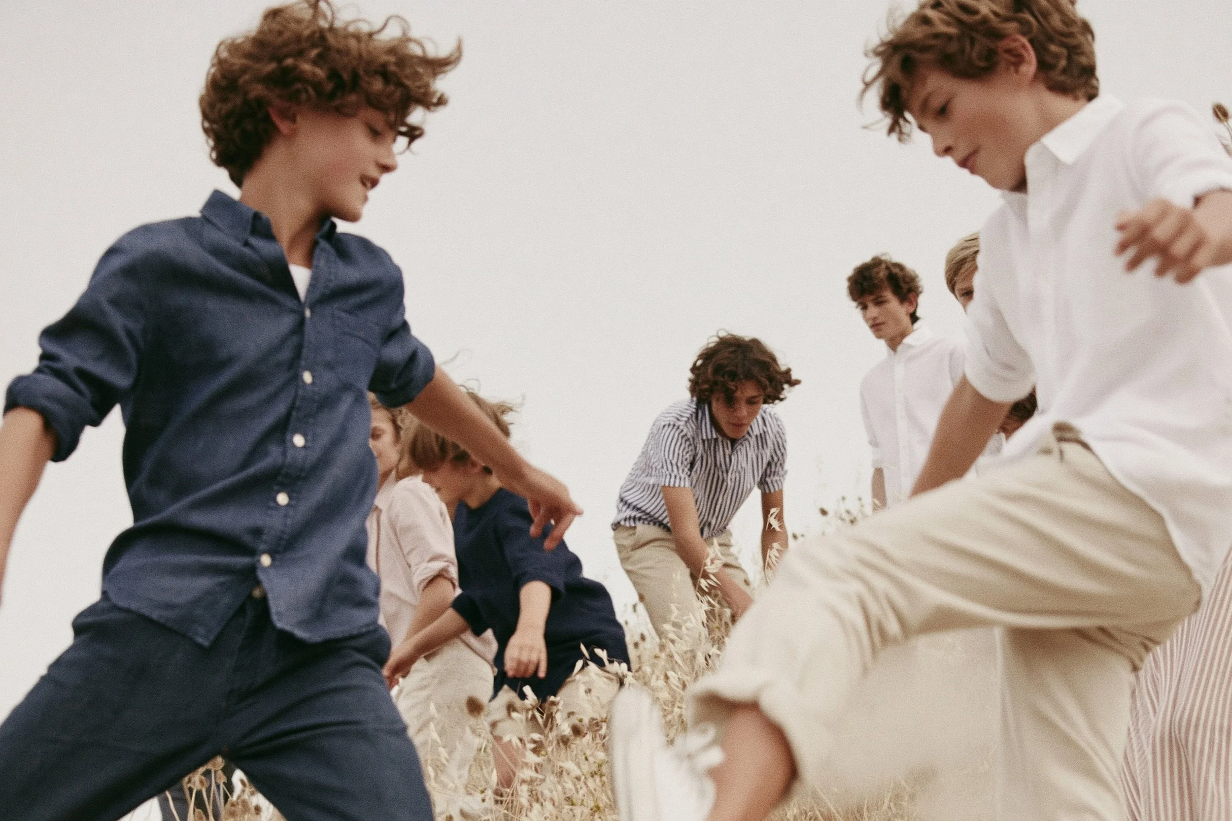 A group of teenagers playing in a field. AI-generated image.