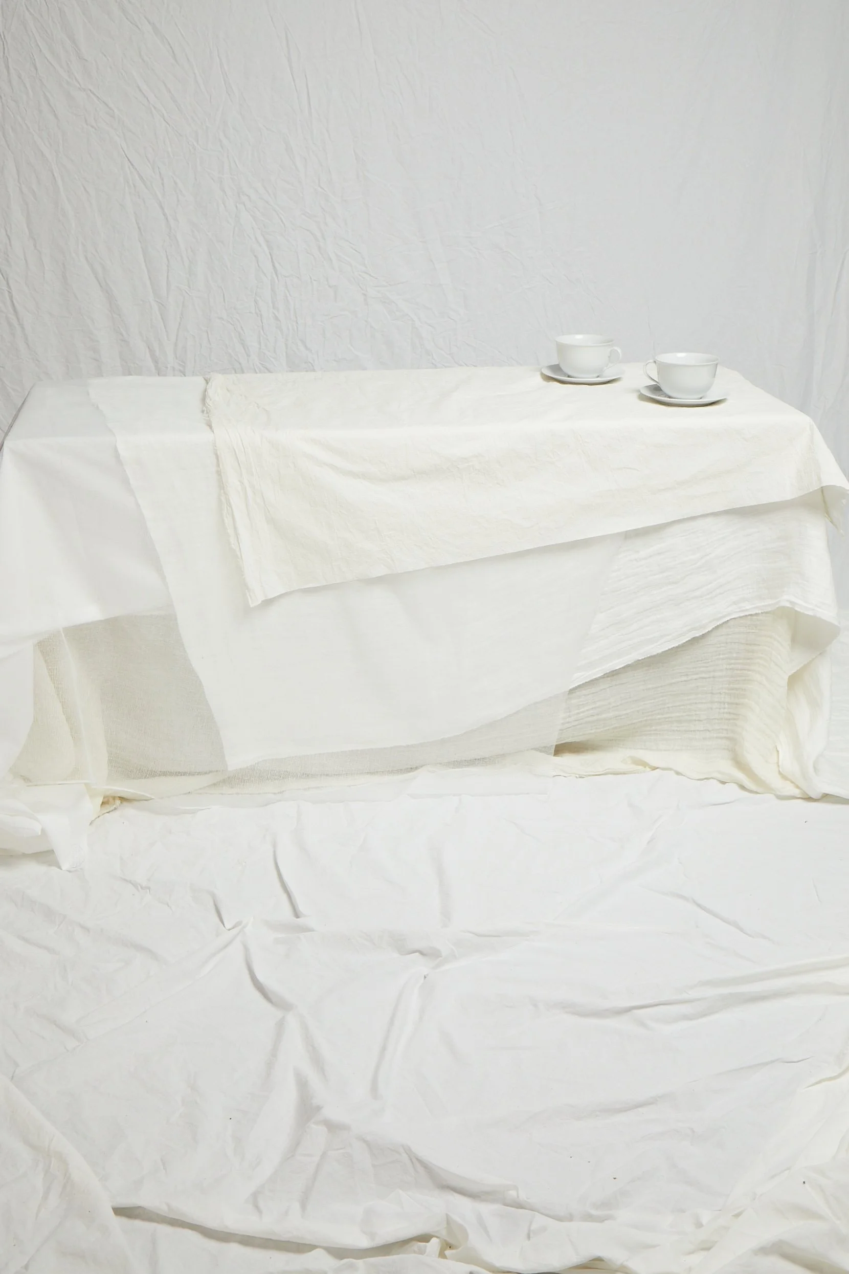 White linen tablecloth with two ceramic cups