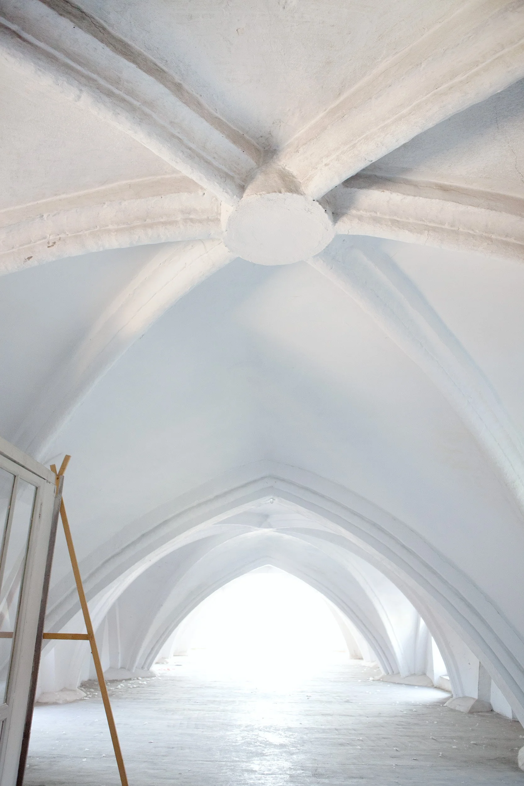 White vaulted ceiling in a historic building, minimal architectural interior