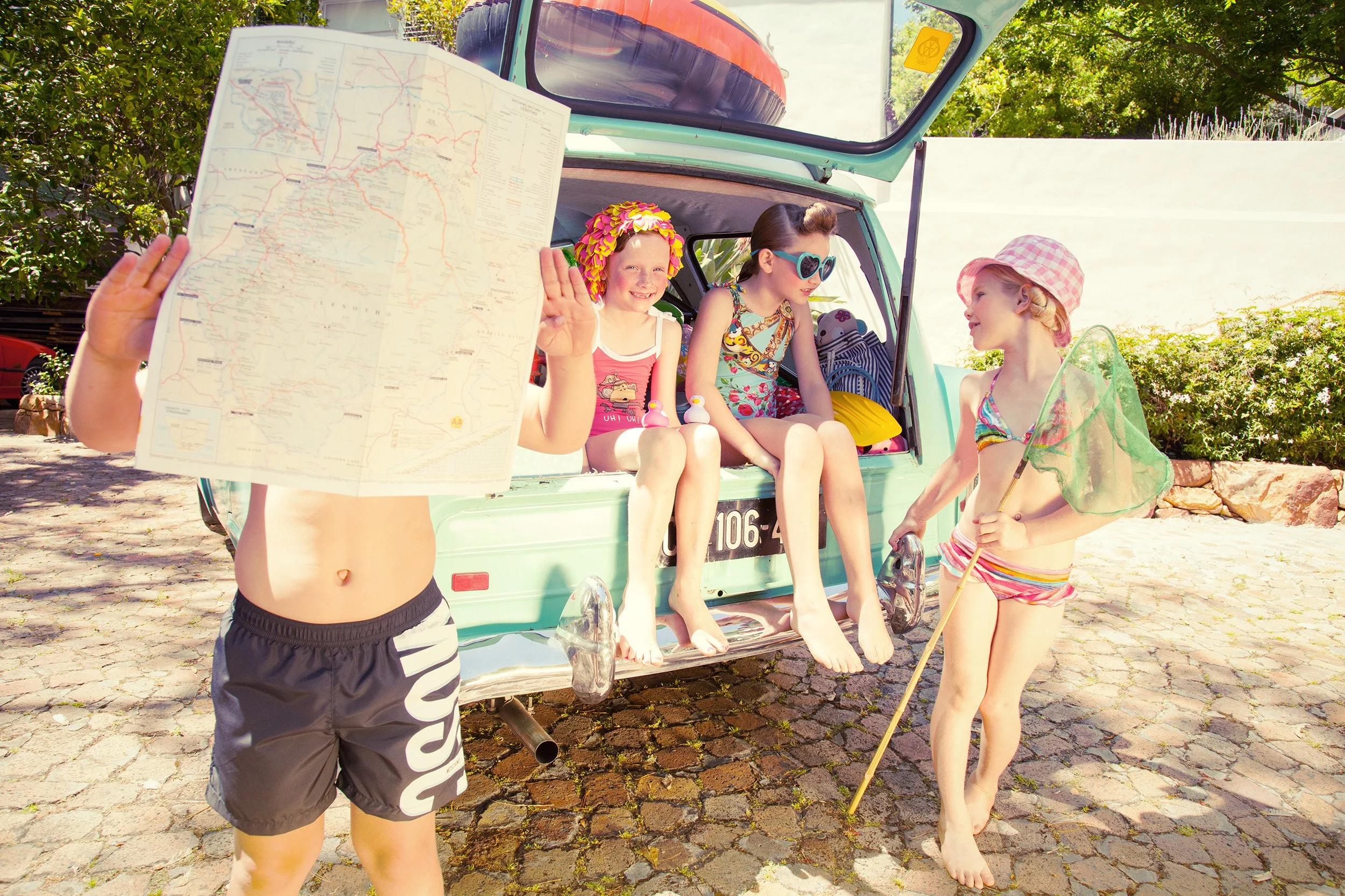 Style Piccoli editorial — children by a vintage van, a boy holding up a map, Cape Town.