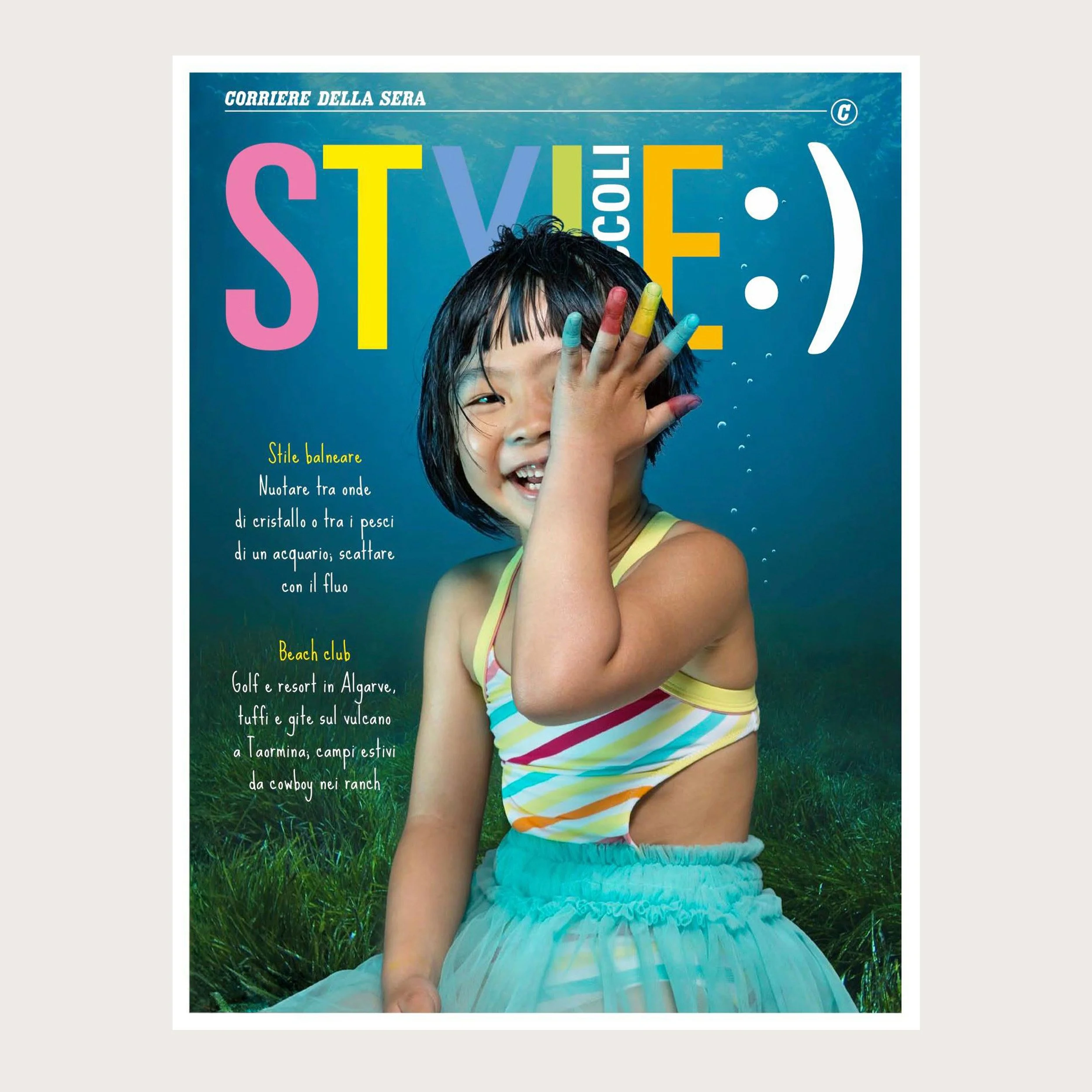 Girl in a striped swimsuit, fingers painted, hand over one eye — Style Piccoli cover, Corriere della Sera.