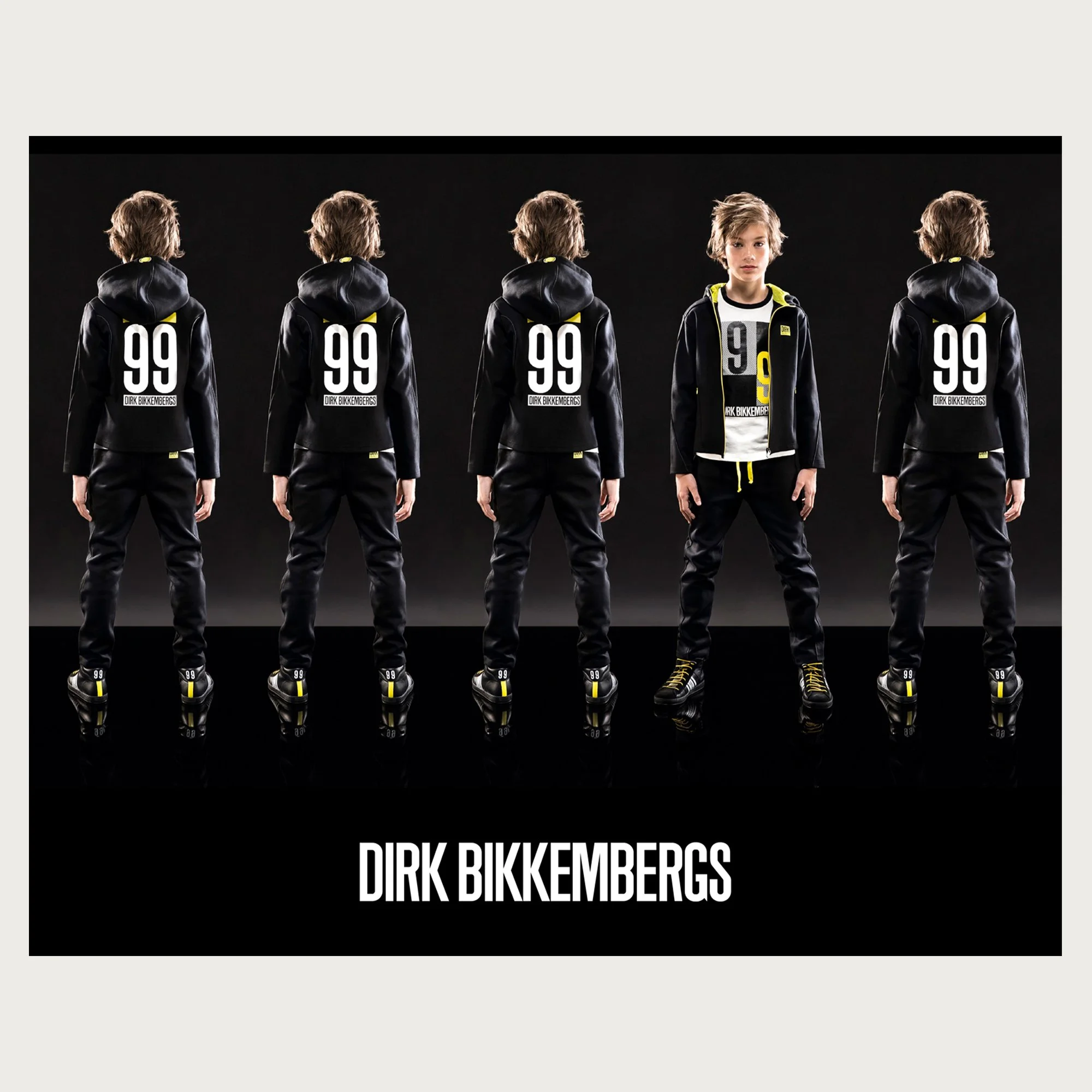 Black hooded sweatshirts numbered 99, one boy turning to camera among four backs — Dirk Bikkembergs campaign.