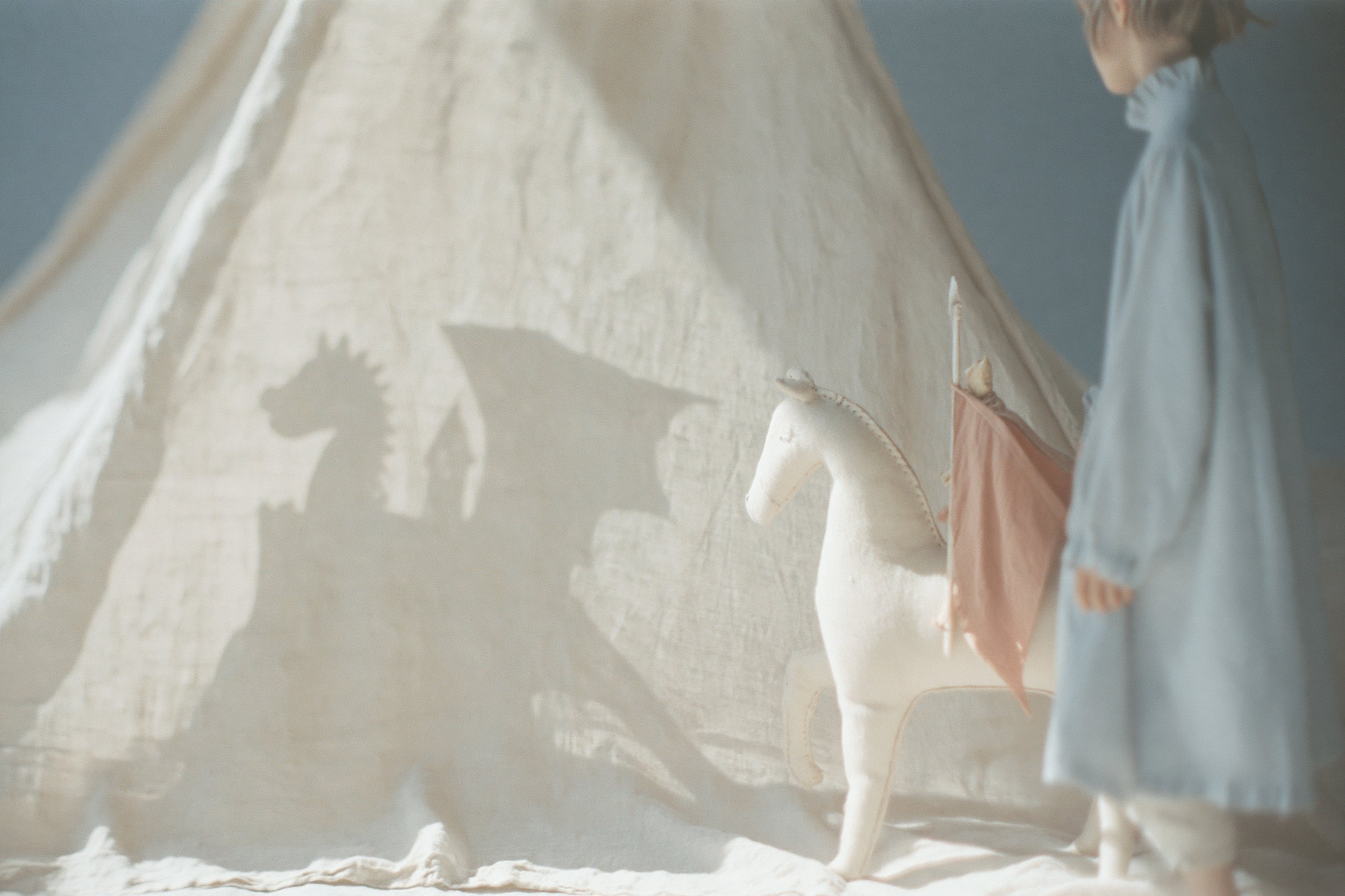 Child's shadow play behind a white linen curtain. AI-generated image.