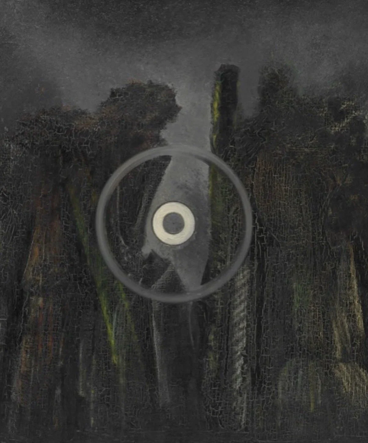 Close-up of a black, dirty, and weathered surface with a circular metallic object at the center, possibly a lock or part of a machinery.